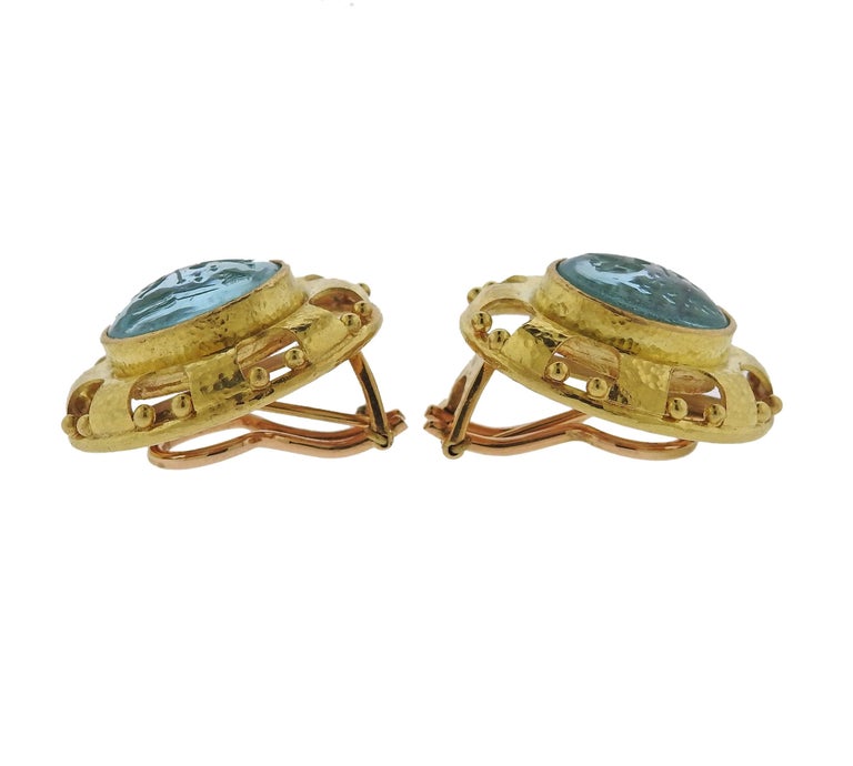 A pair of 18k yellow gold earrings, crafted by Elizabeth Locke, set with blue Venetian glass, backed with mother of pearl. Earrings measure  26mm x 25mm and weigh 24 grams. Marked: 18k, E mark 