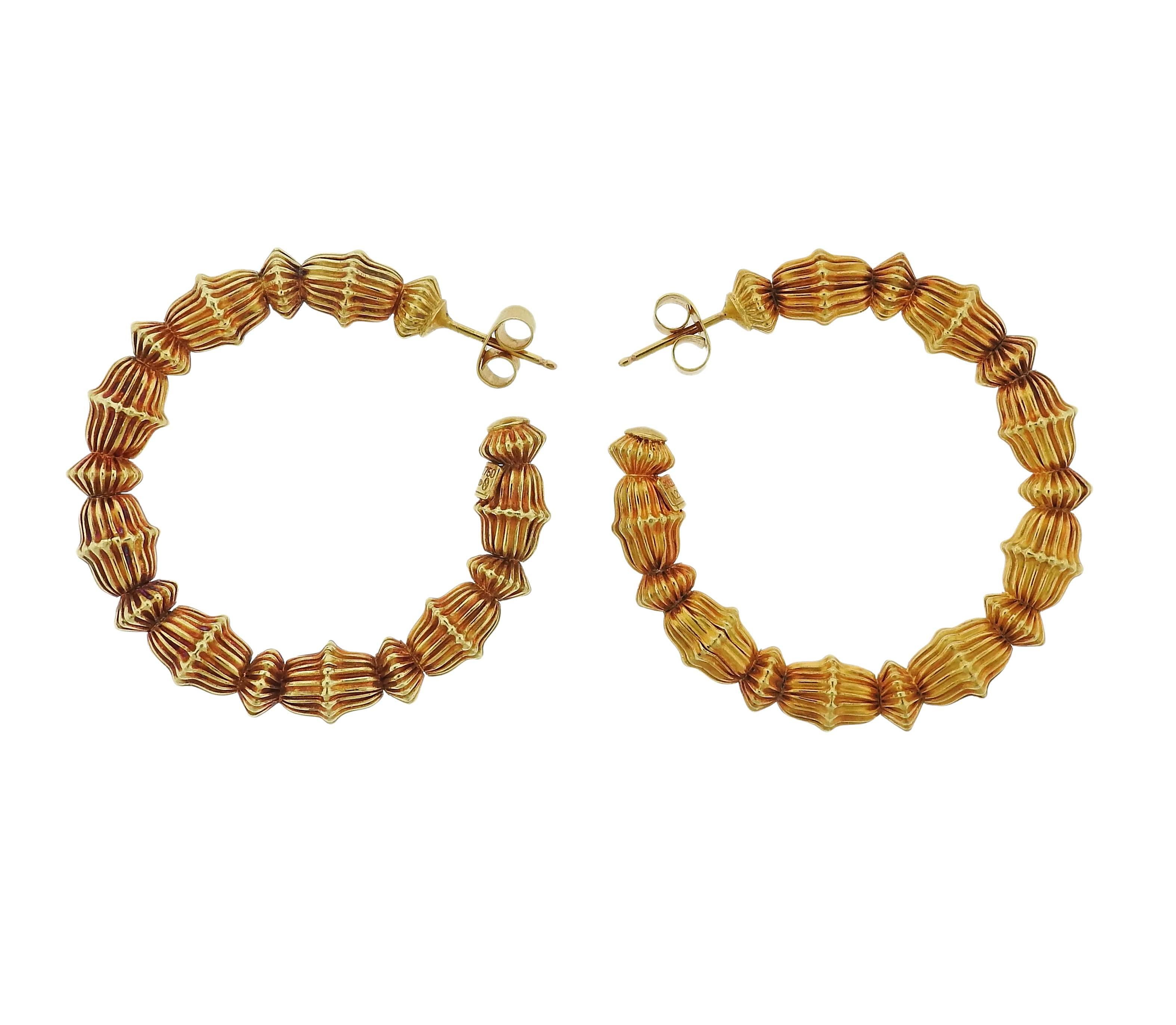 Pair of 18k yellow gold hoop earrings, crafted by Ilias Lalaounis. Earrings are 41mm in diameter and 6.5mm wide , weigh 19.9 grams. Marked: Greece, 750, Maker's mark , A21
