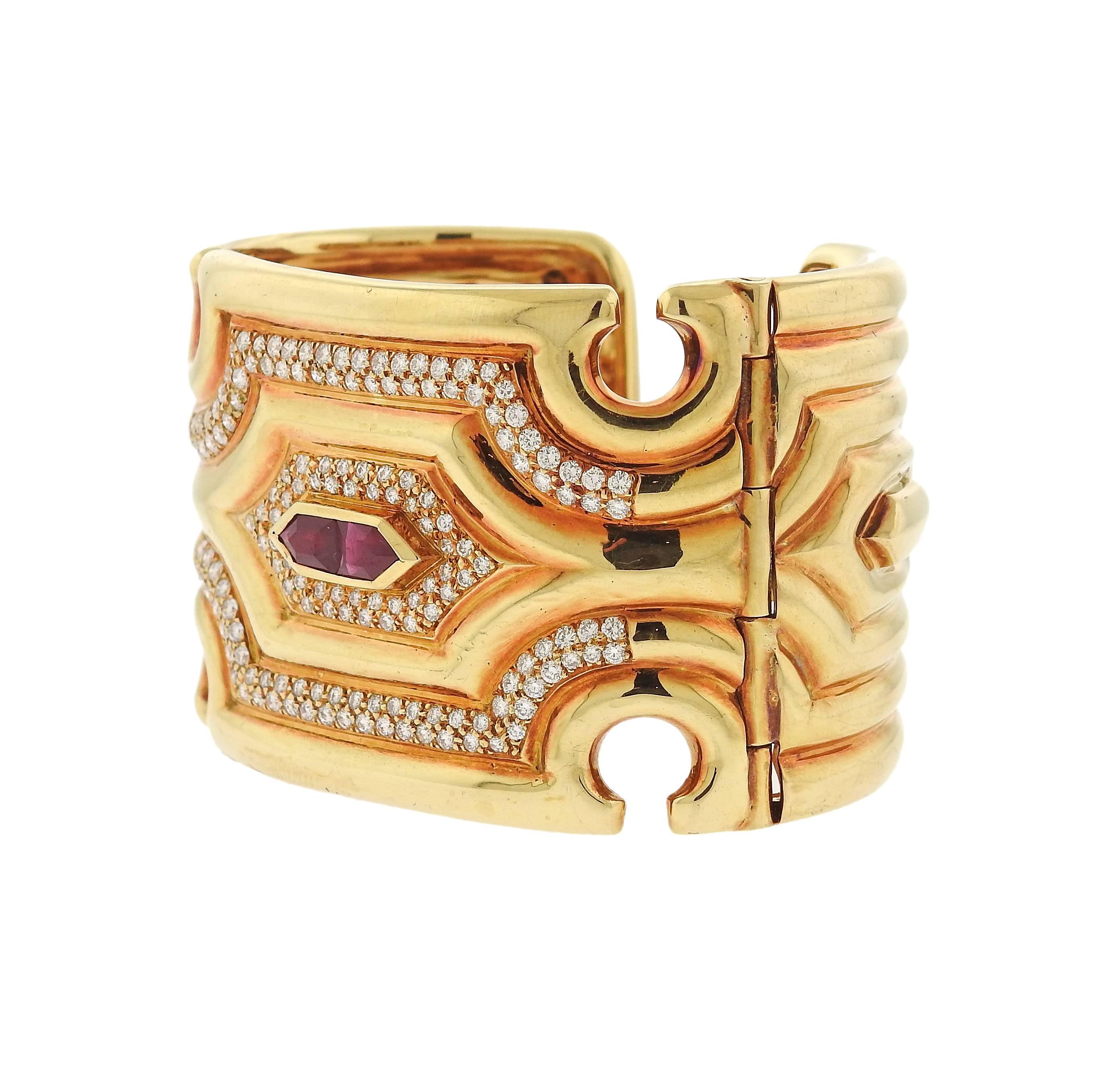 Impressive 18k yellow gold cuff bracelet, set with approximately 2.60ctw in diamonds and rubies. Bracelet will fit approx. 6 1/4" wrist and is 40mm wide , weight - 134.4 grams. Marked 750. 
