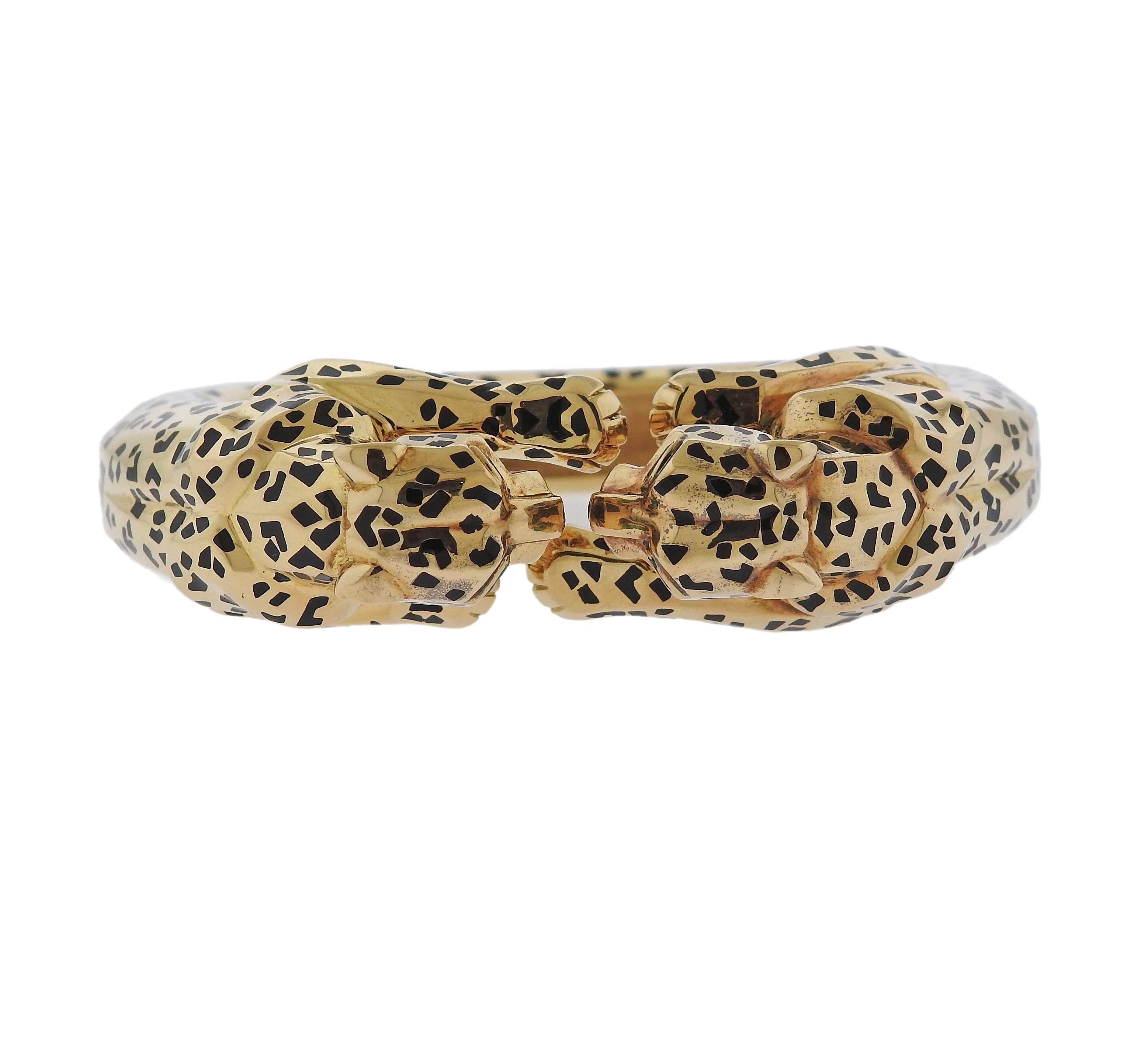 Rare iconic Panther bracelet, crafted by Cartier, set with enamel and emerald eyes. Bracelet will fit approx. 7 1/2" wrist and is 20mm wide ( leopards measure approx. 20mm x 21mm x 30mm each ). Marked: 633503, Cartier, 750, French gold