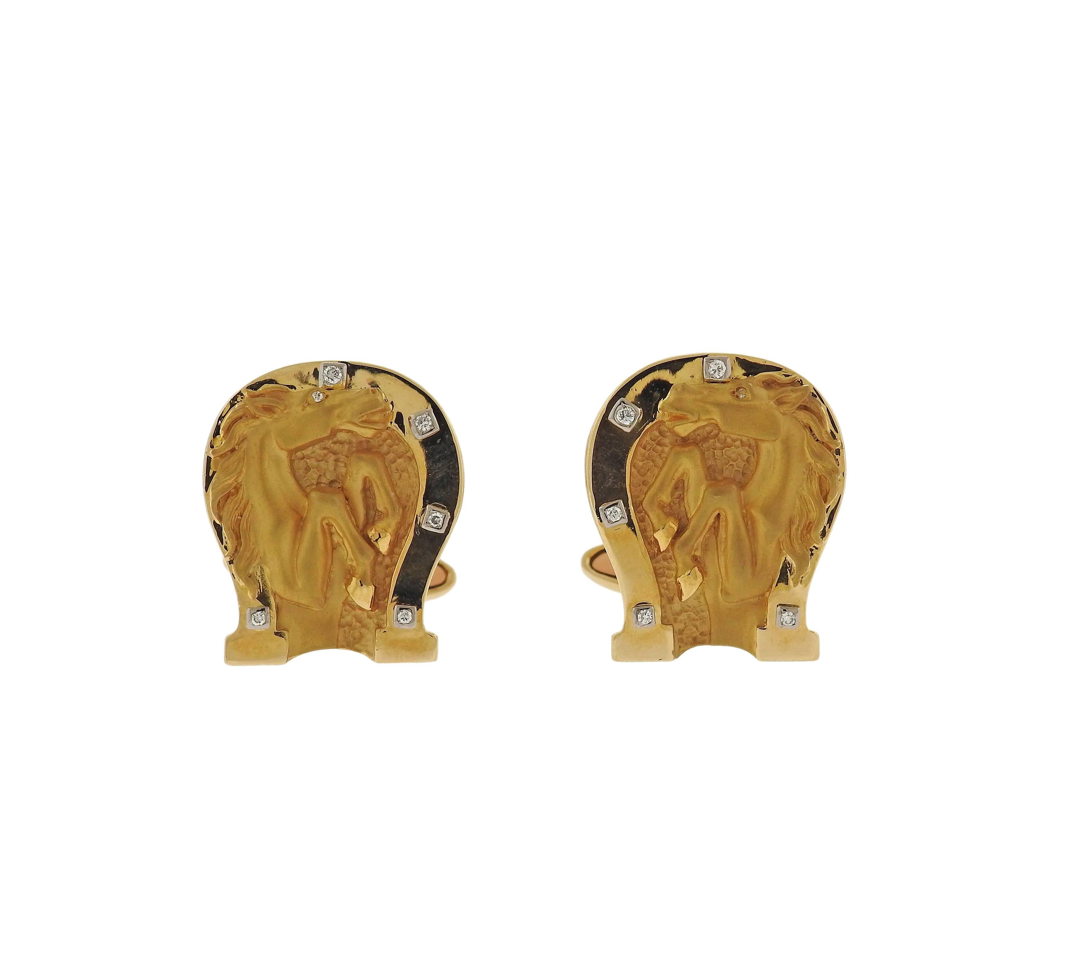 Pair of 18k yellow gold horse shoe cufflinks, featuring horse head image in the center. Decorated with diamonds. Cufflink top measures 21mm x 18mm. Marked: Cc mark, 750. Weight - 19 grams 