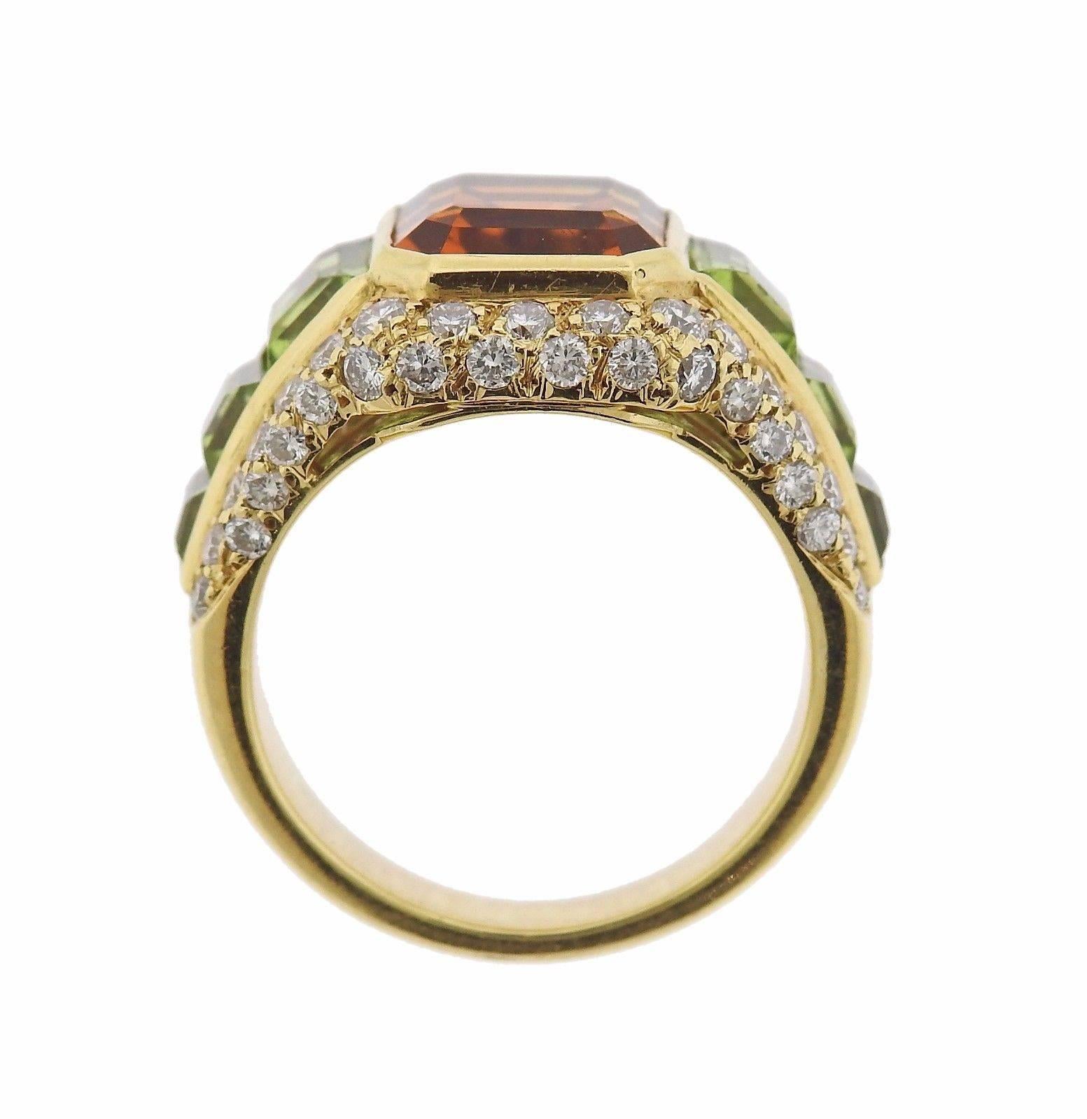 An 18k yellow gold ring set with a 3.3ct citrine which is accented by peridot and approximately 0.70ctw of G/VS diamonds.  The ring is a size 6 1/4 and it is 15mm wide.  The weight of the piece is 11.2 grams.  Marked: 750, Bvlgari, BA9214.