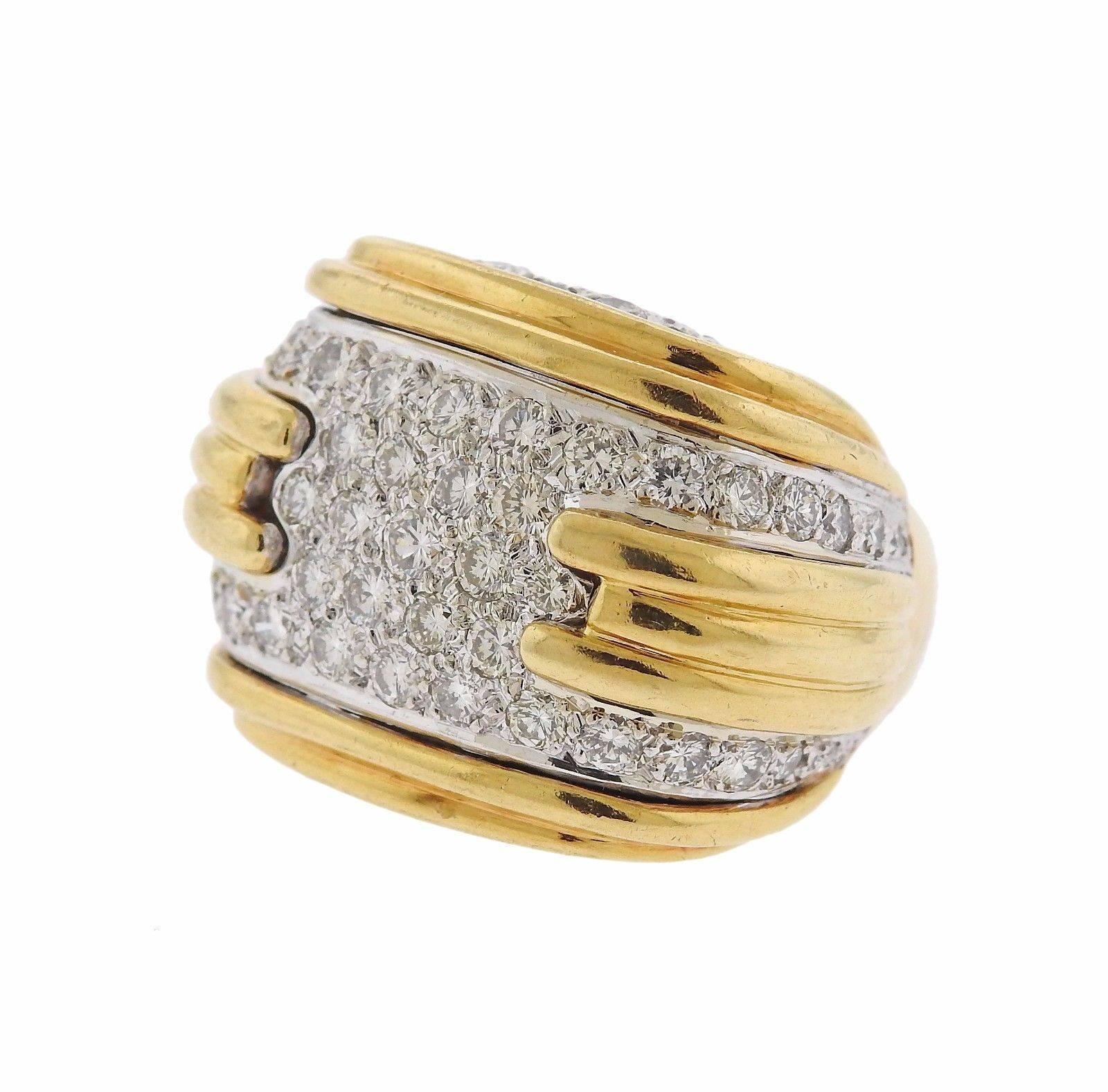 An 18k yellow gold ring set with 4 carats of G-H/VS diamonds.  The ring is a size 6 1/2 and the top measures 23mm x 32mm.  The weight of the piece is 35.7 grams.