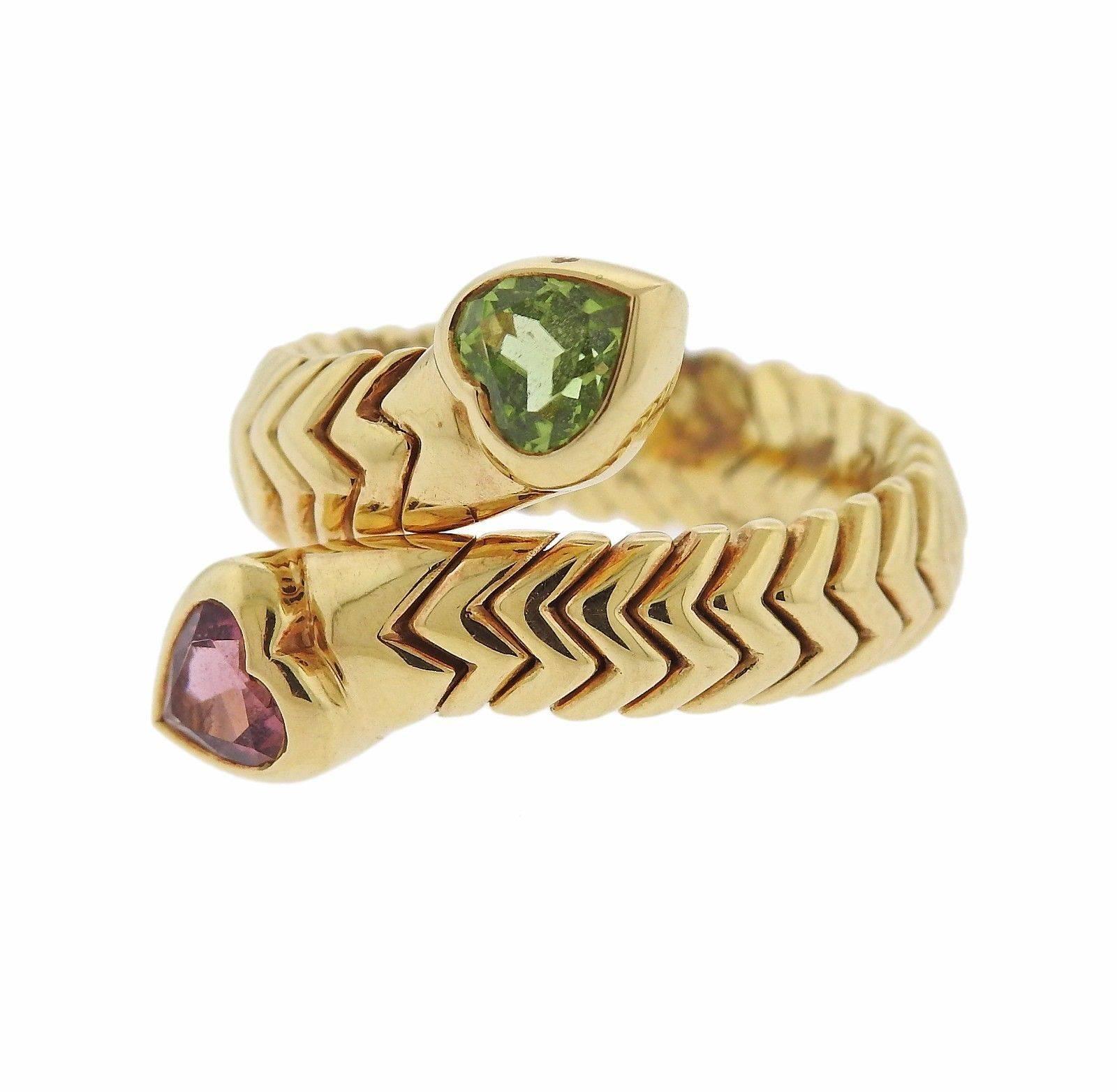 An 18k yellow gold ring set with pink tourmaline and peridot.  The ring is a size 6 1/2 and the top is 20mm wide.  The weight of the piece is 13.6 grams. Marked: 750, Bvlgari.