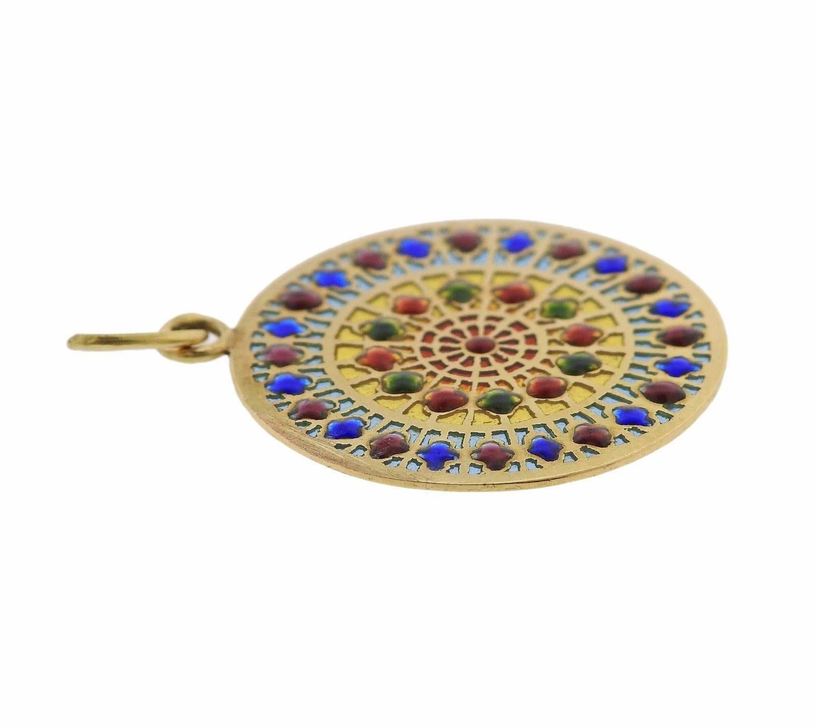 An 18k yellow gold pendant adorned with enamel stained glass.  The pendant measures 23.5mm in diameter and weighs 2.2 grams.  Marked: French Eagle assay mark.