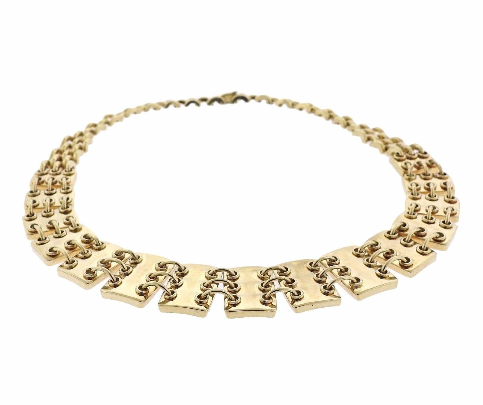 A 14k yellow gold necklace by Jose Hess.  The necklace is 14 3/4" long and 19mm wide.  The weight of the necklace is 84.3 grams.  Marked: 111682, Jose Hess, 14k.