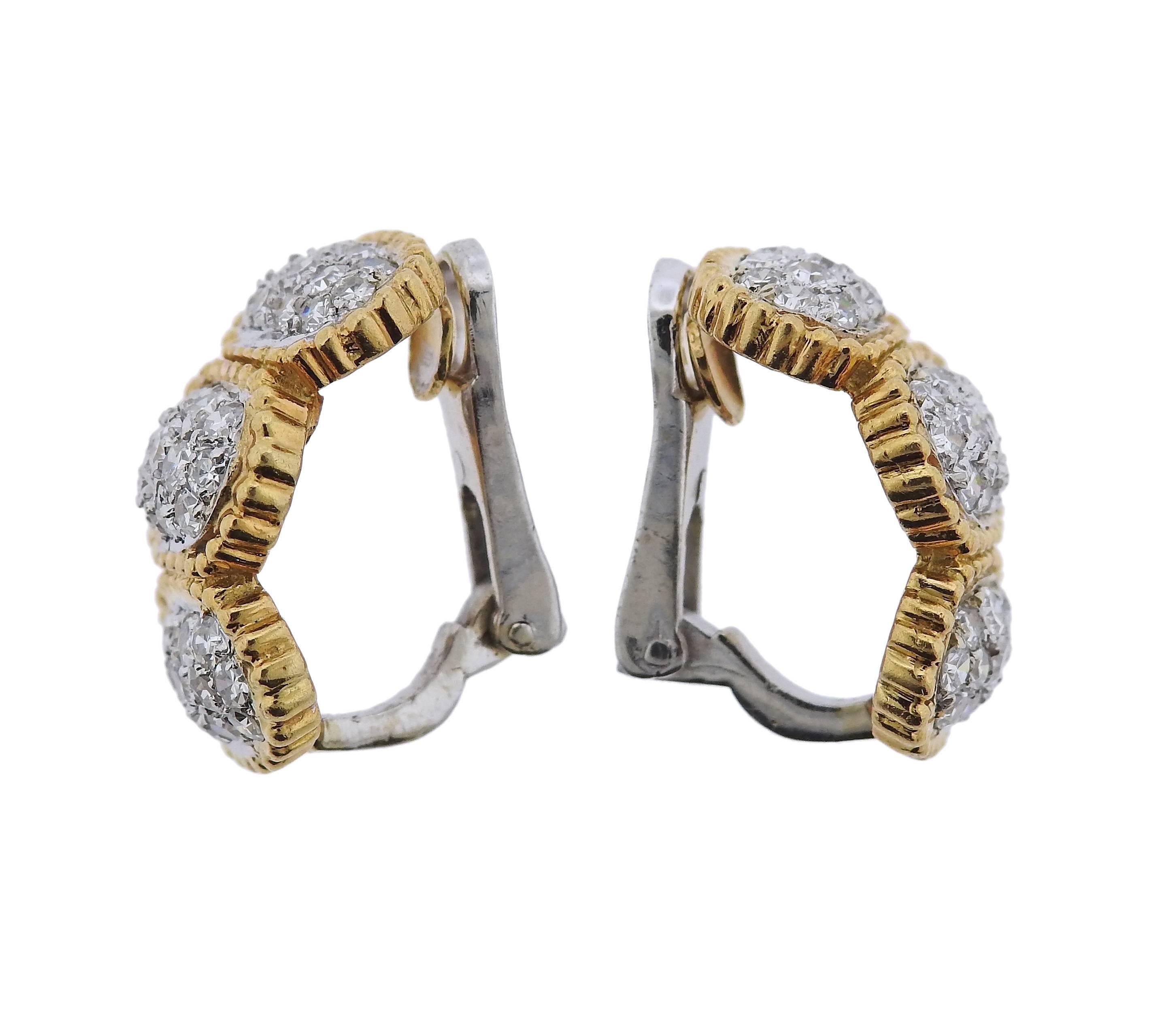 Pair of 18k gold half hoop earrings, set with approximately 0.80ctw in diamonds. Earrings are 20mm x 11mm, weigh 10.7 grams.