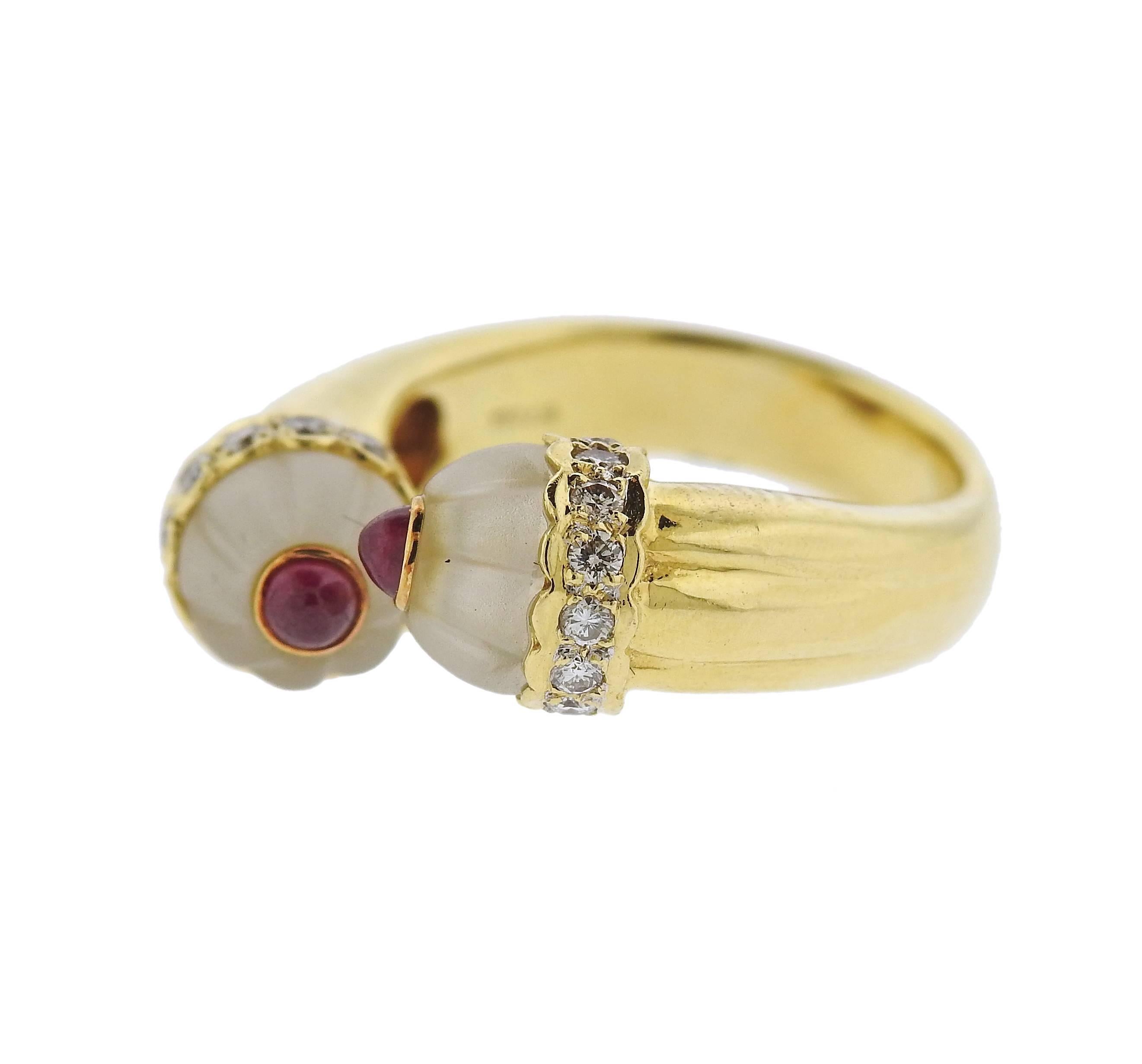 An 18k yellow gold bypass ring, set with carved frosted crystal, ruby cabochons and 0.30ctw in diamonds. Ring size 6, ring top is 8mm wide, weight - 9.1 grams. Marked: 750 18k, D030, 027.