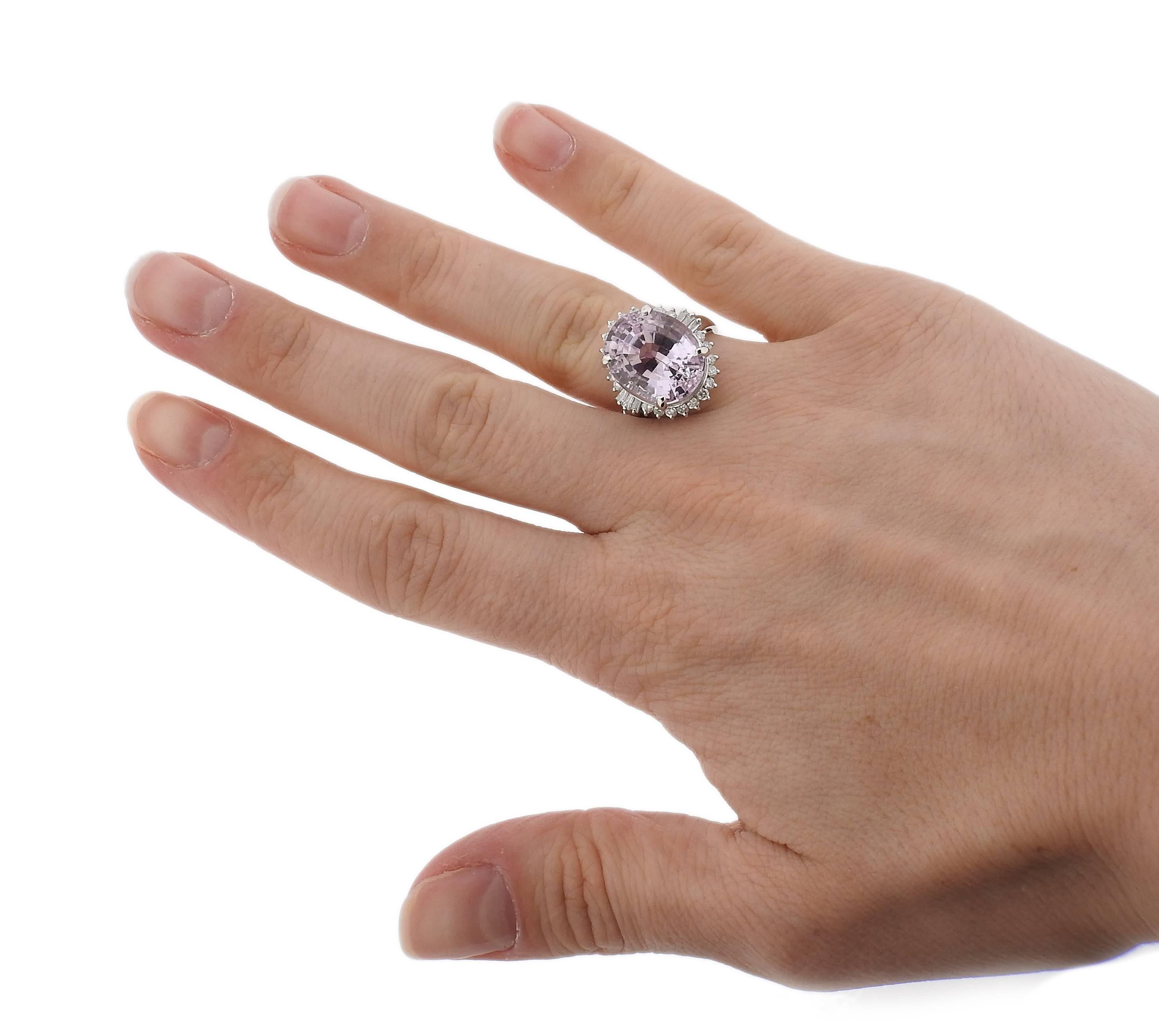 Platinum cocktail ring, set with a 13.82ct kunzite, surrounded with 0.57ctw in diamonds. Ring is a size - 6 1/4, ring top is 18mm x 16mm.  Marked: D057, pt900, 13.82.  Weight - 11.7 grams. 