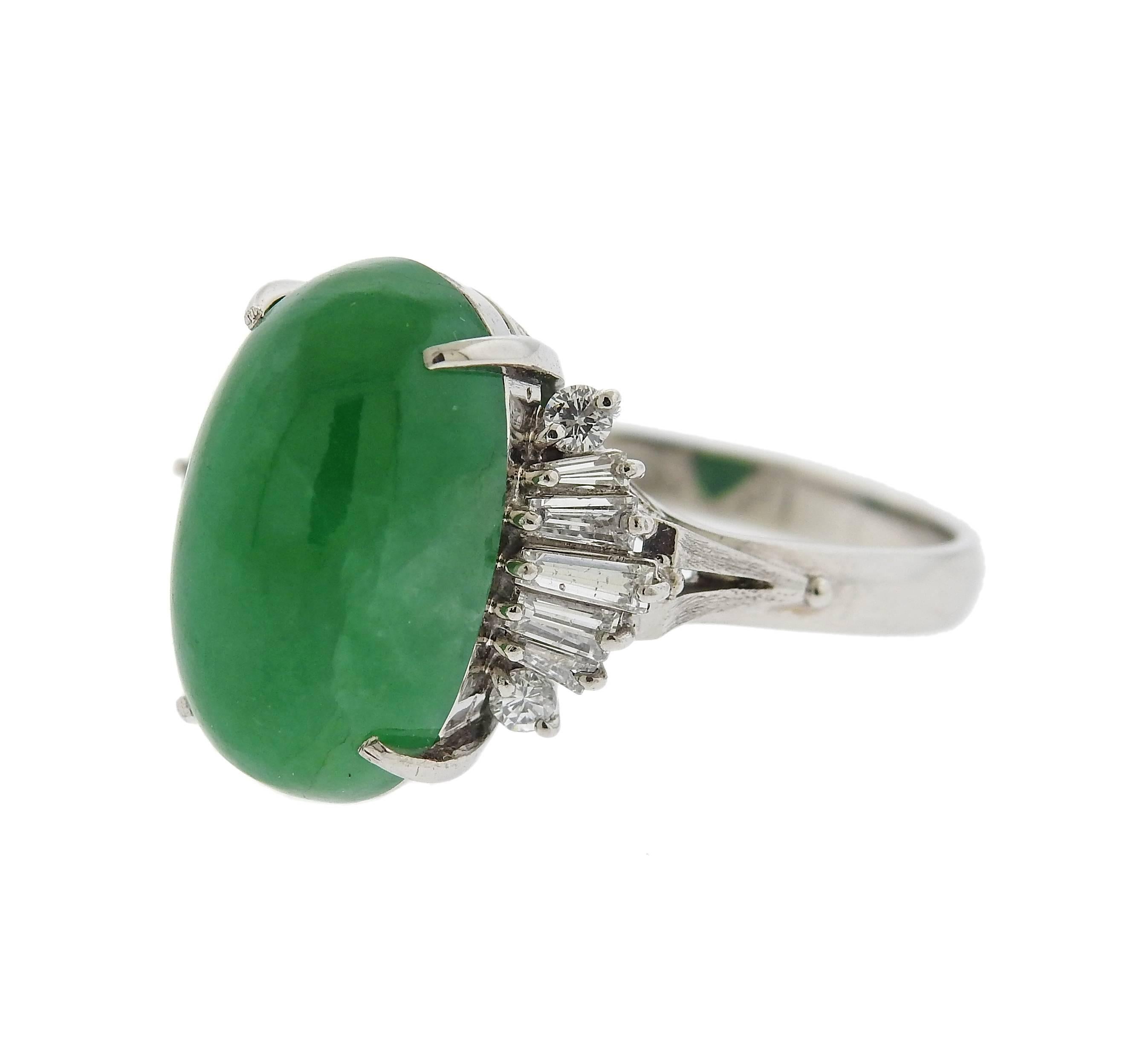 Platinum ring, set with oval jade cabochon, weighing 10.87ct, surrounded with 0.61ctw in diamonds. Ring size 8 3/4, ring top measures 17mm x 18mm. Marked: 10.87, Pt850, D0.61.  Weight of the piece - 9.2 grams.