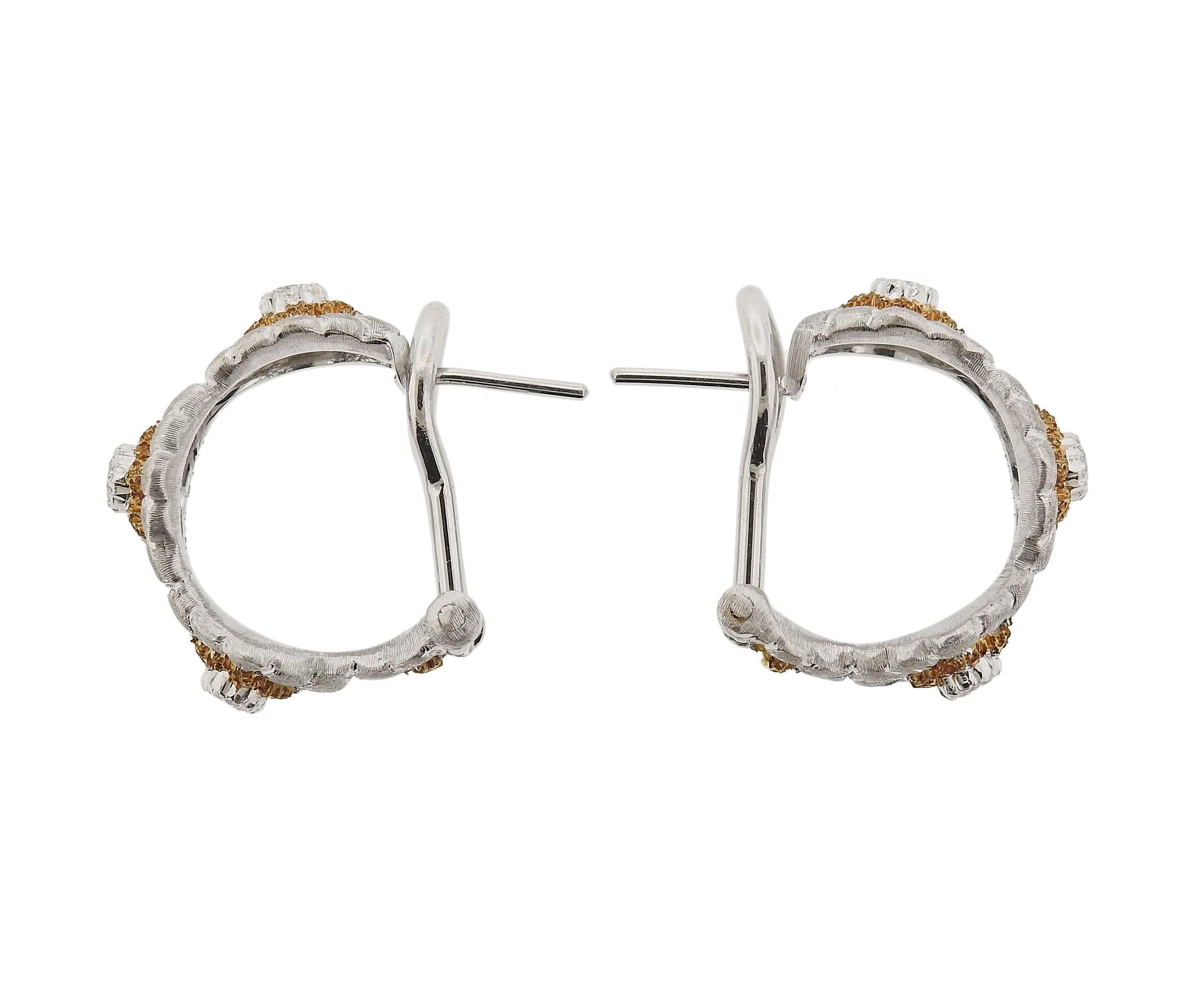 A pair of delicate flower hoop earrings. crafted by Buccellati, set in 18k yellow and white gold, with approximately 0.36ctw in diamonds. Earrings are 20mm in diameter, and 10mm wide, weigh 11.9 grams. Marked: Buccellati, 750,18k, Italy,