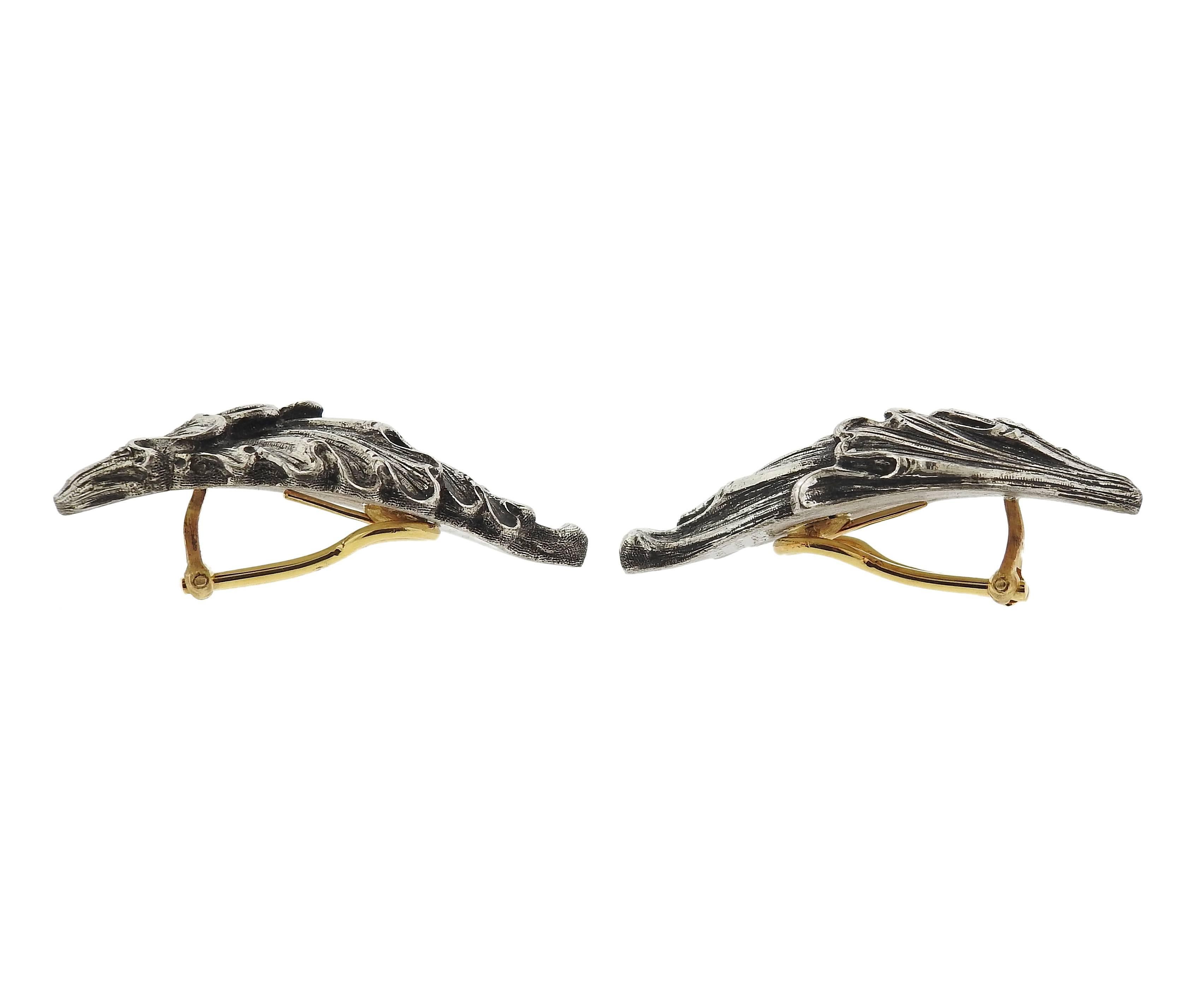 Pair of silver and 18k gold wing motif earrings, crafted by Buccellati. Earrings are 41mm x 19mm, weigh 16 grams. Marked: 	
Gianmaria Buccellati, Italy, 925, K1462. 
Come with pouch. Retail $ 5400.