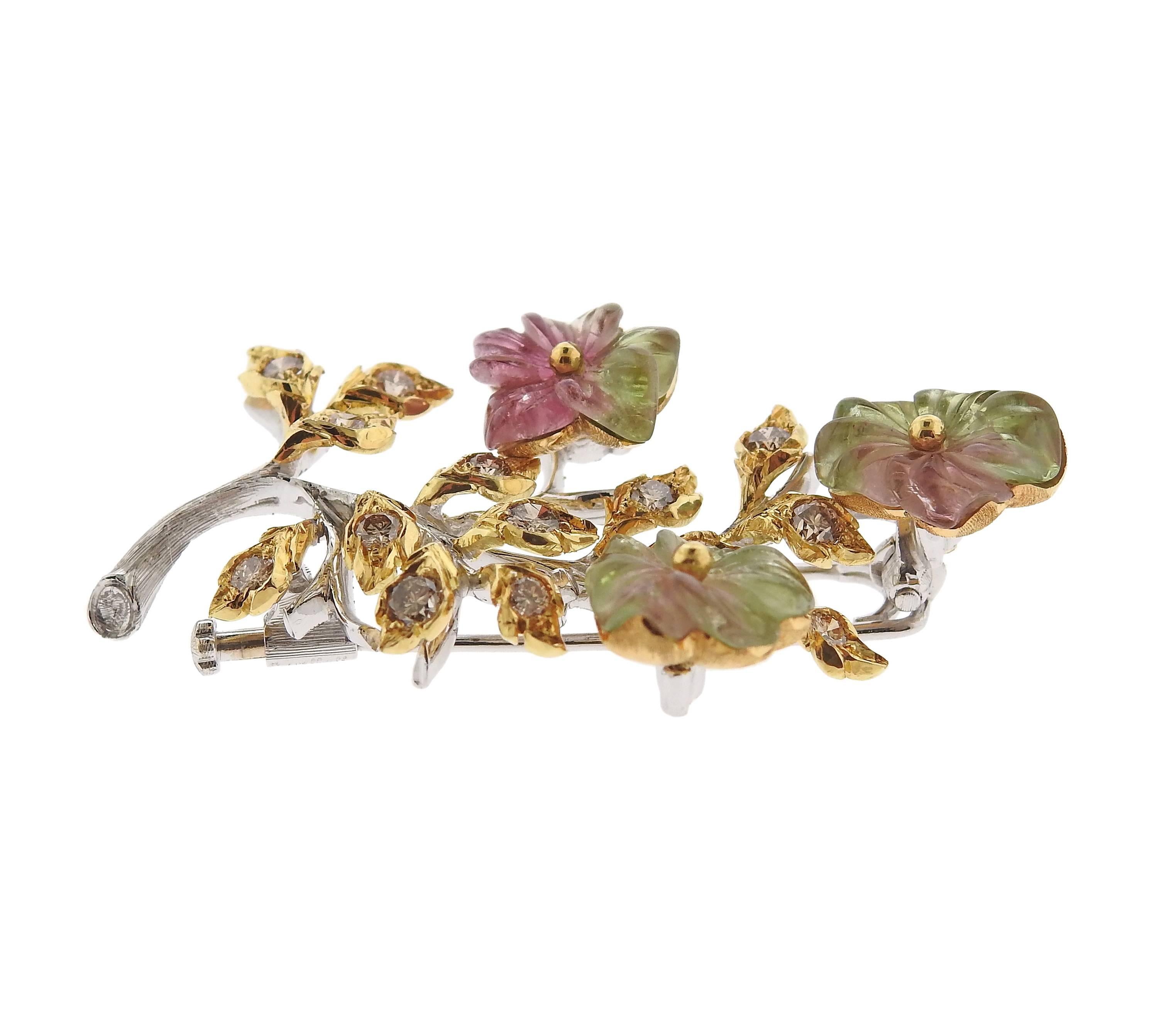 An 18k gold brooch, crafted by Buccellati, decorated with carved tourmaline set in flowers, surrounded with approximately 0.70ctw in diamonds. Brooch measures 48mm x 28mm, weighs 13.5 grams. Marked: Buccellati, 750, P4789, Italy.
Comes with pouch.