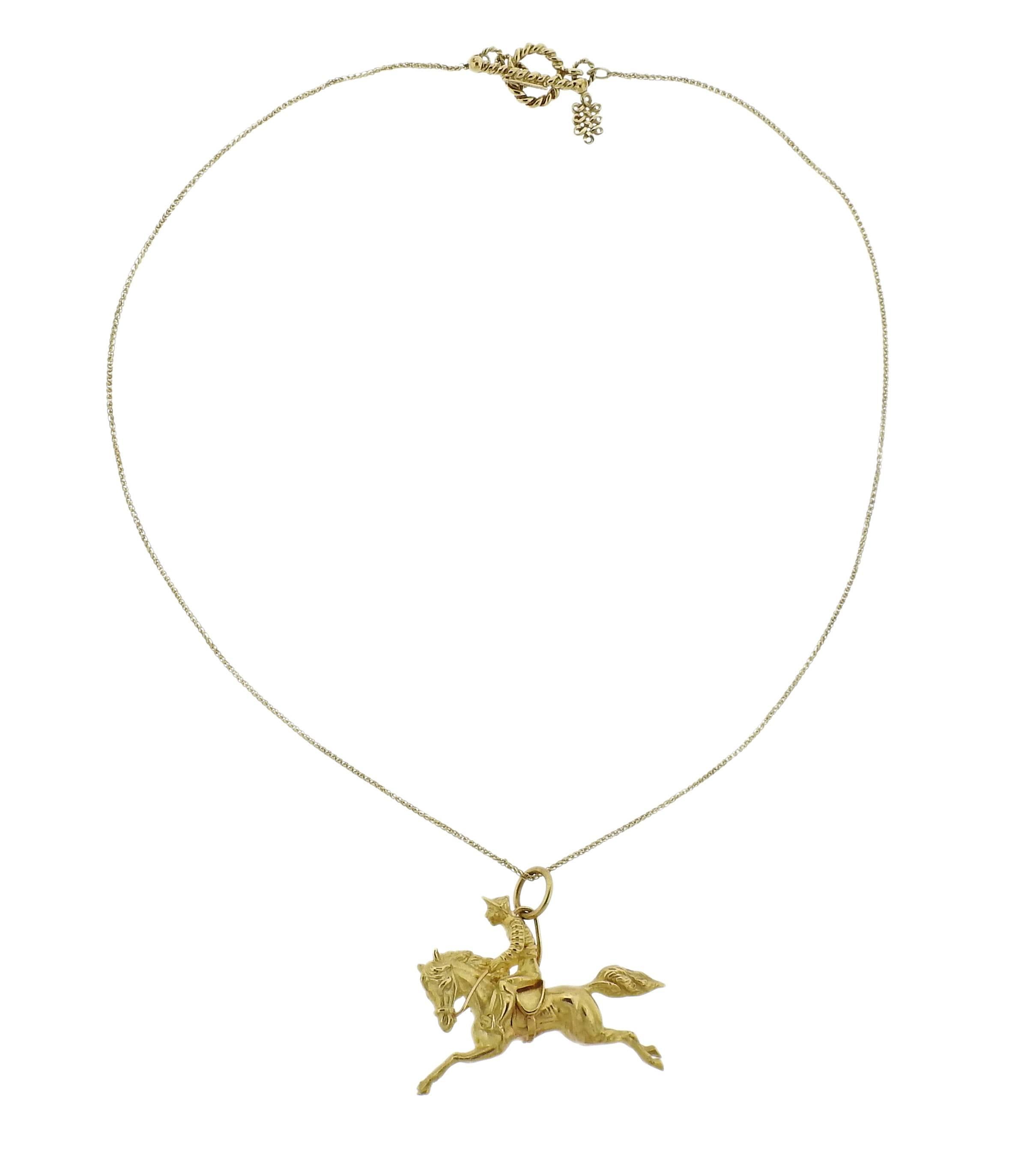 An 18k yellow gold necklace with Jockey pendant. Necklace is 16 3/4