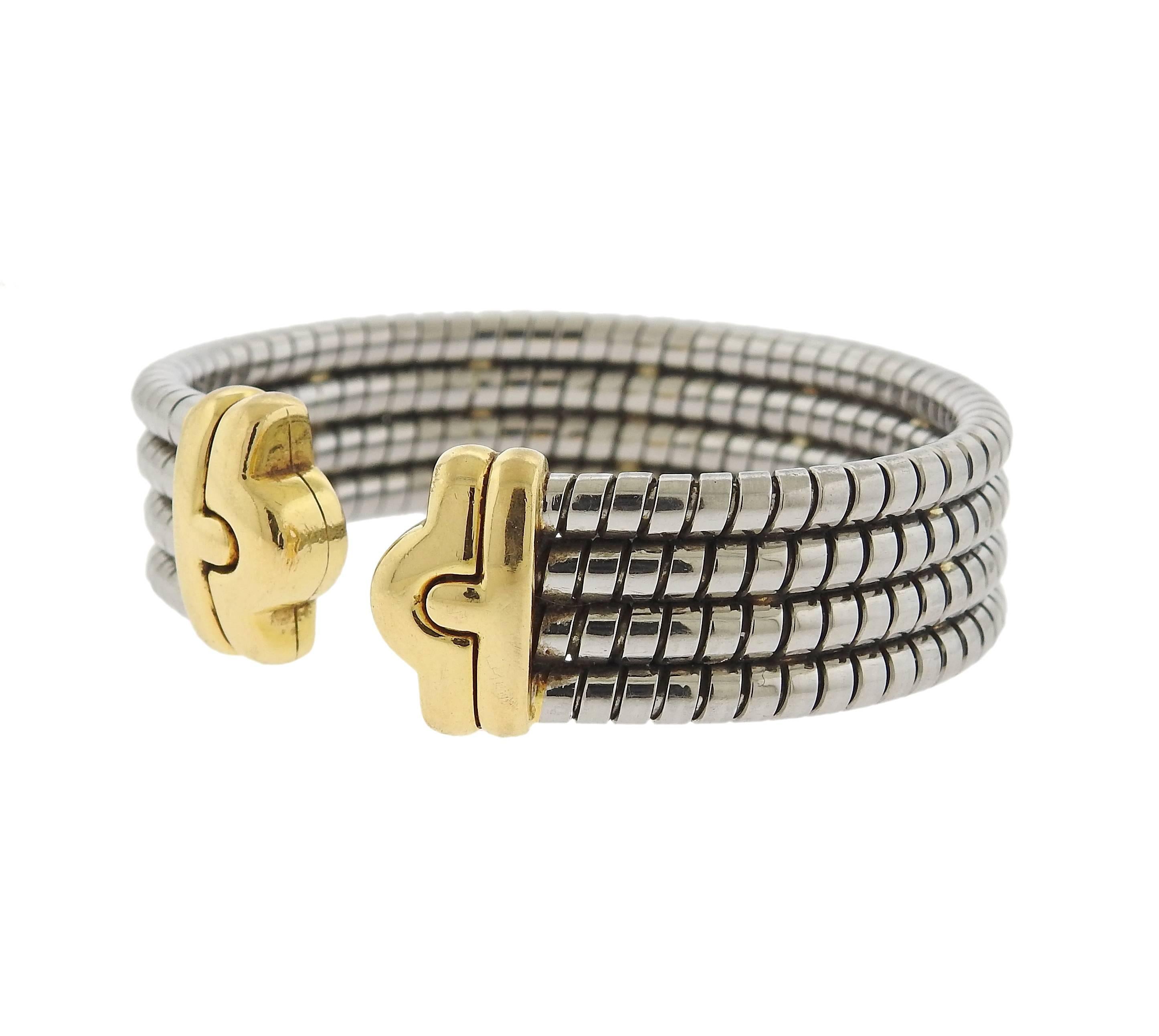 An 18k yellow gold and steel cuff bracelet, crafted by Bulgari for iconic Parentesi collection. Bracelet will comfortably fit approximately 7" - 7 1/2" wrist and is 17mm wide. Marked: Bvlgari, 750, Italian mark, M. Weight - 51.7 grams. 