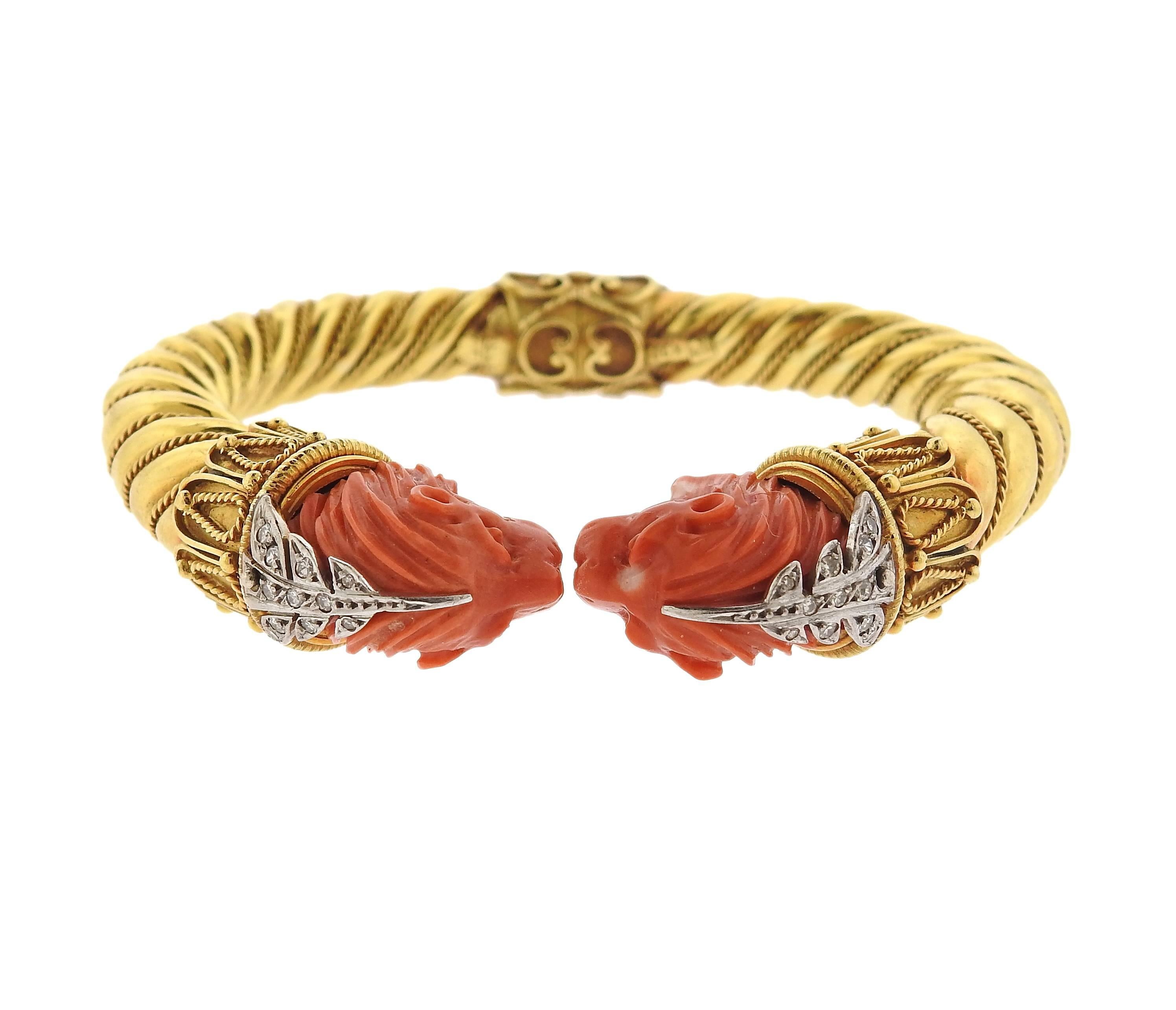 Greek 22k gold bangle bracelet, featuring  lion heads, set in carved coral, decorated with approximately 0.20ctw in diamonds. Bracelet will fit an approximately 7" wrist, each  lion head measures 14mm x 20mm. Marked: Greece, k22, GIT.  Weight
