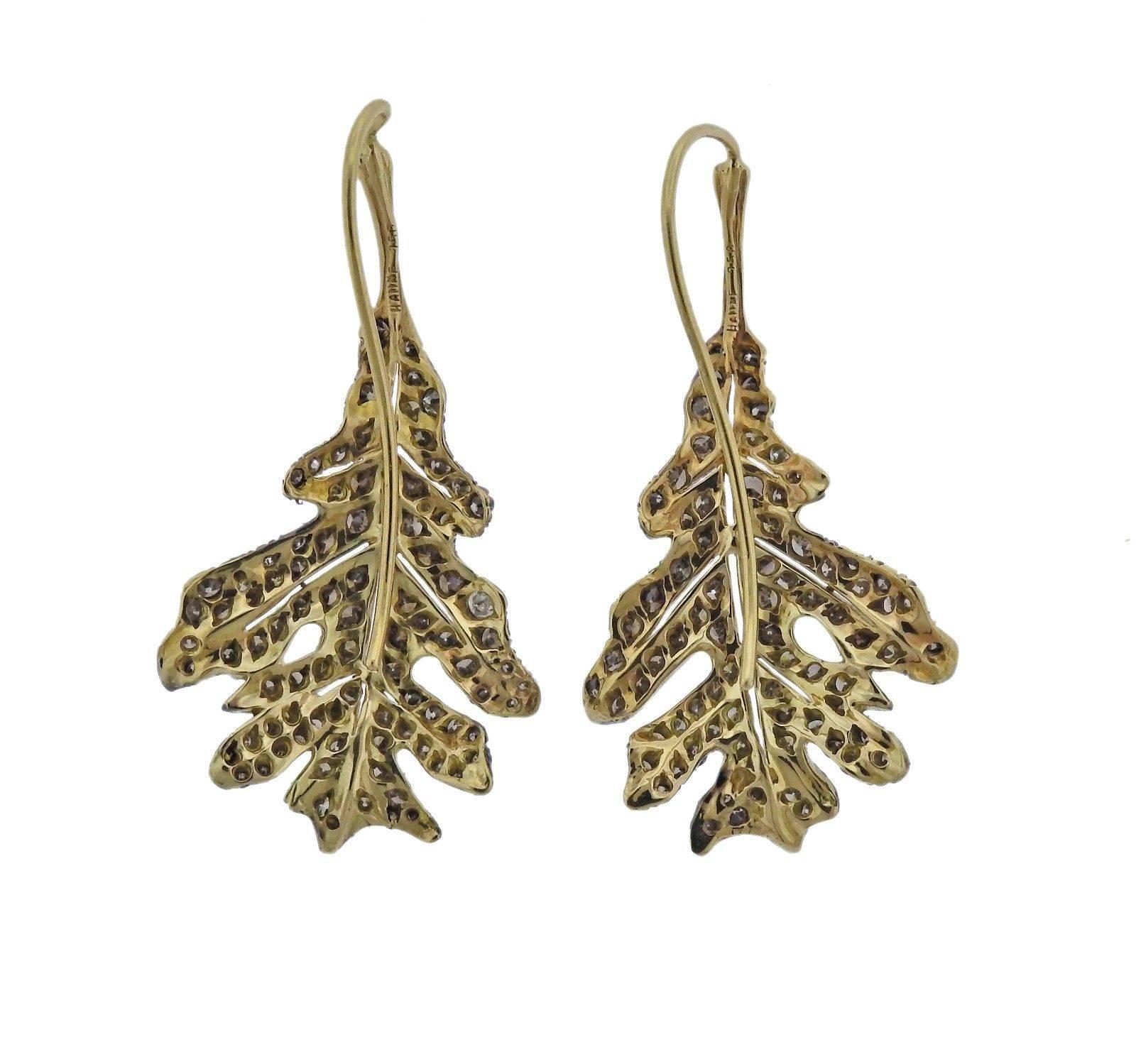 A pair of 18k gold earrings depicting leaves, set with approximately 2 carats of fancy diamonds.  Crafted by Adria de Haume, the earrings measure 43mm x 22mm and weigh 9.8 grams.  Marked: Haume, 750.