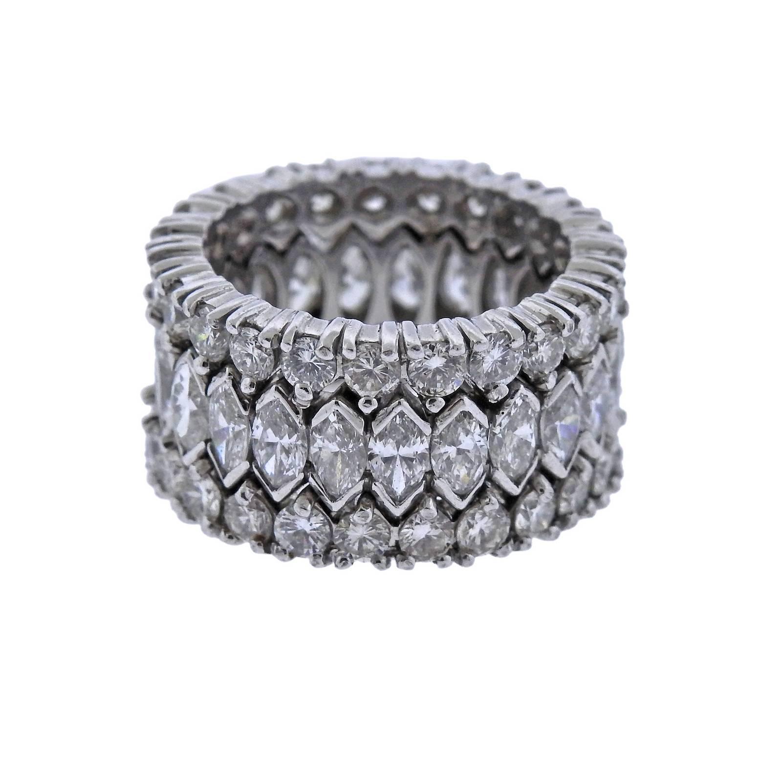 A platinum eternity band ring featuring approximately 3.50ctw of round brilliant cut diamonds and approximately 3.26ctw of marquise diamonds, all G color and VS-SI2 clarity. Ring size - 6 1/4, ring is 11.9mm wide and weighs 19.6 grams. 