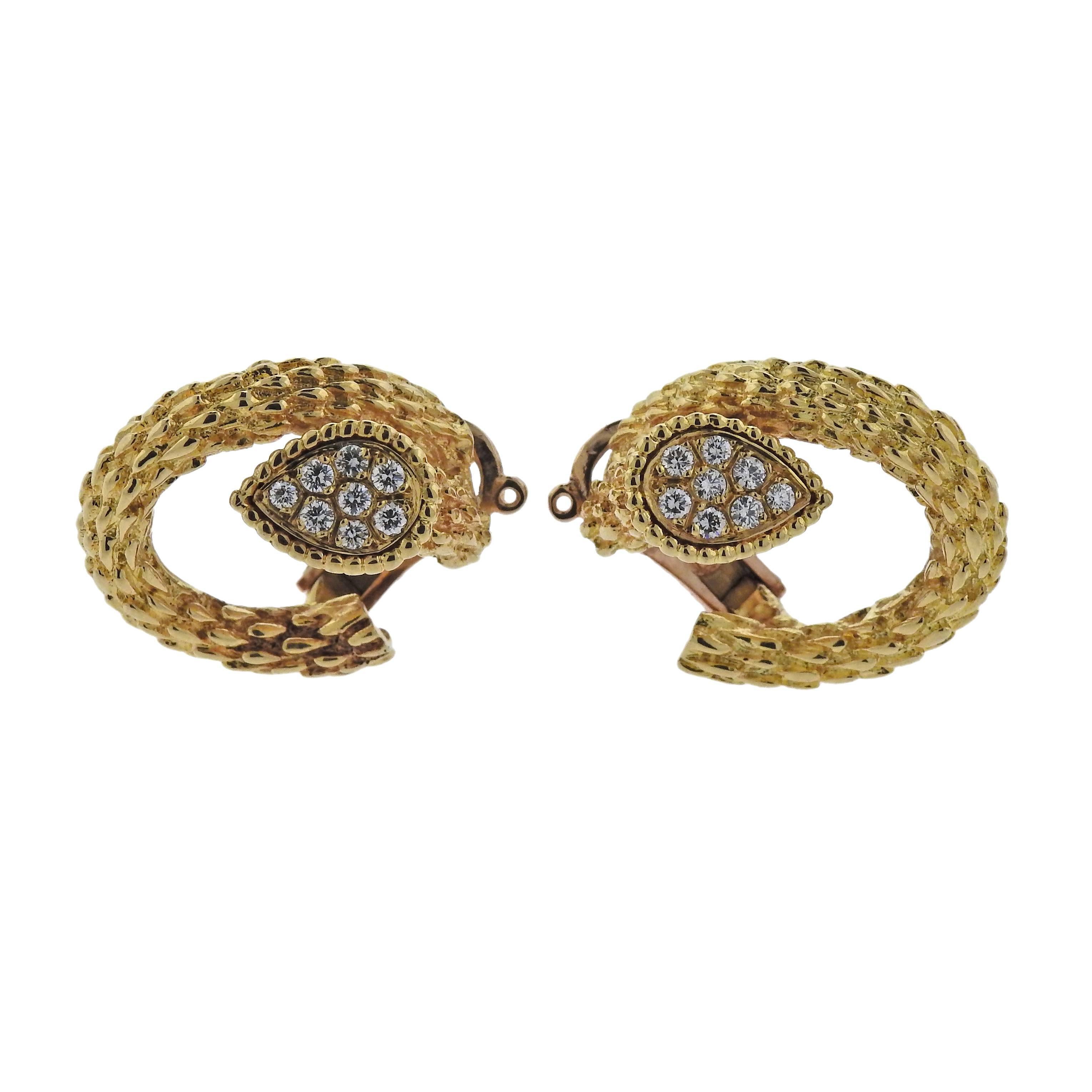 Pair of beautiful 18k yellow gold earrings, crafted by Boucheron, set with approximately 0.50ctw in G/VS diamonds. Earrings are 24mm x 21mm and weigh 20.7 grams. Marked: 497, or750, Boucheron.
