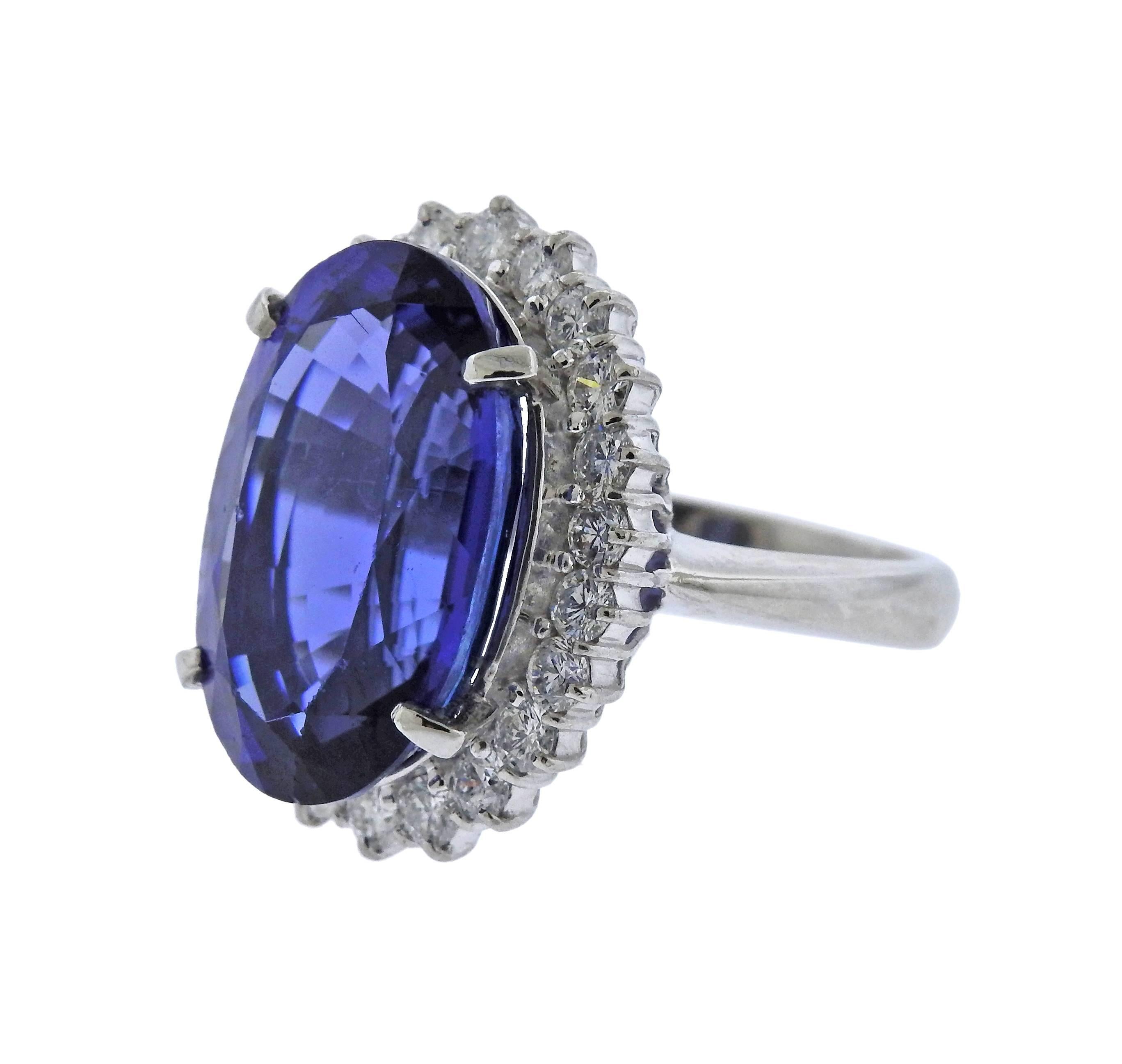 Impressive 19.69ct oval tanzanite gemstone, adorned with 1.63ctw in diamonds around, in platinum ring setting. Ring size - 8 1/4, ring top is 24mm x 20mm, weighs 18.9 grams. Marked: 19.69, D1.63, Pt900.