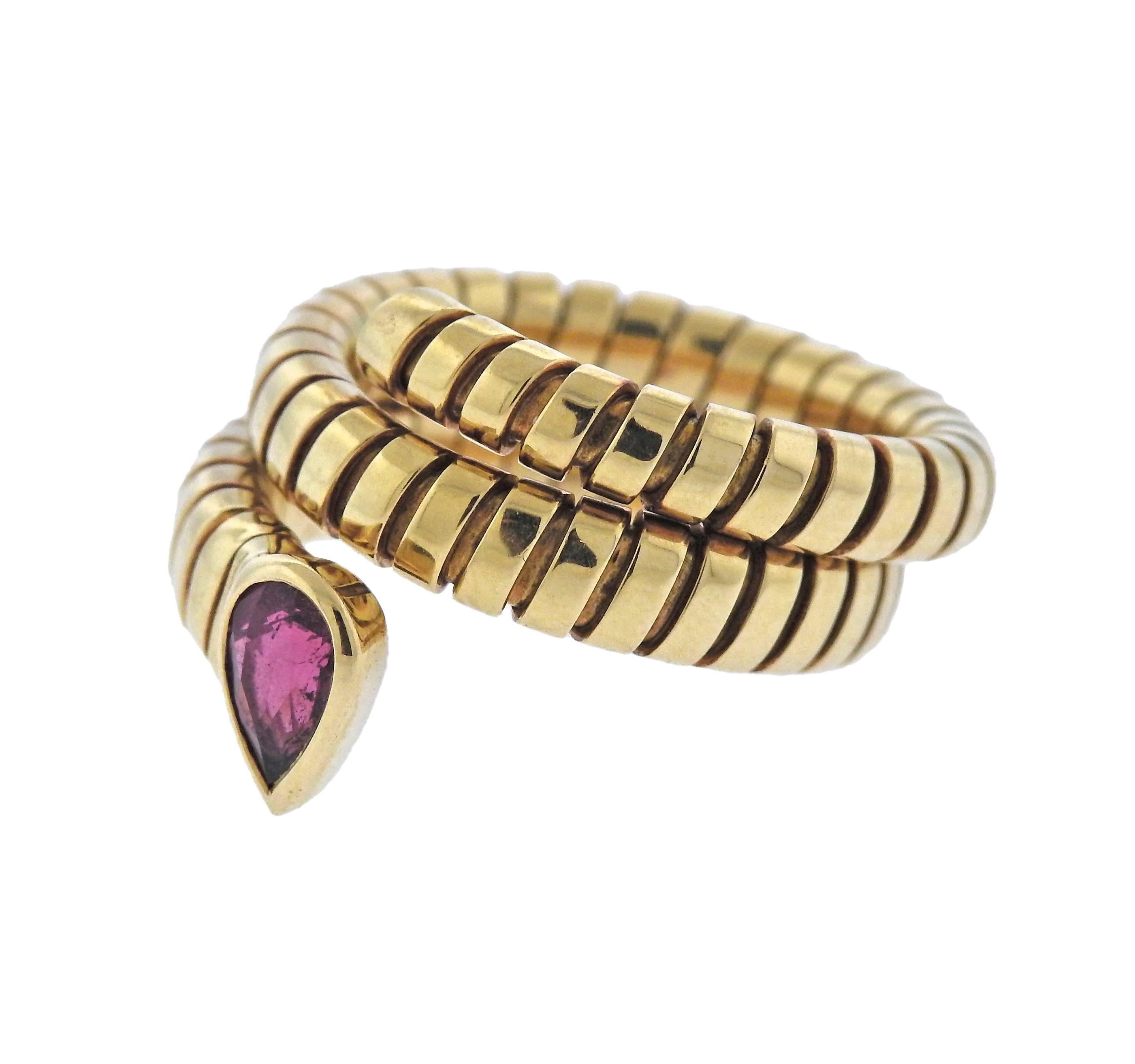 Classic Tubogas wrap ring, in 18k yellow gold, decorated with pink tourmaline, designed by Bulgari. Ring size - 7, top o the ring is 16mm wide, weighs 14.3 grams. Marked: Bvlgari, 750.