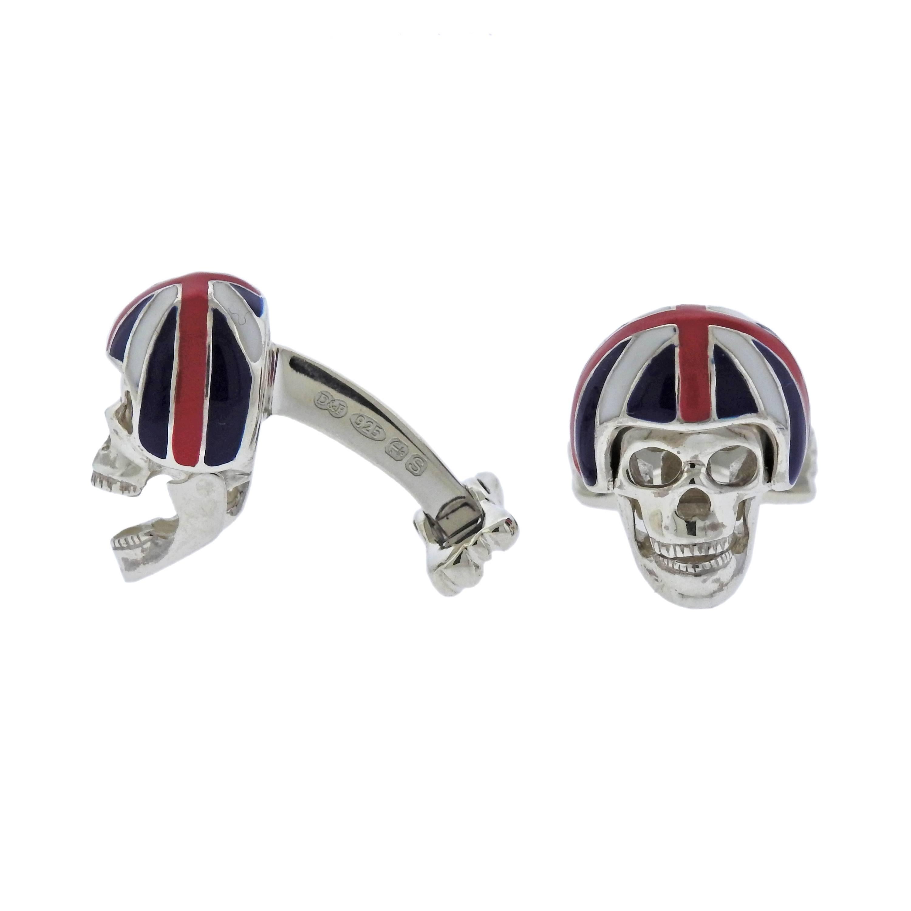  Pair of new sterling silver skull cufflinks, crafted by Deakin & Francis, featuring signature movable jaws, revealing pink spinel eyes, with enamel Union Jack helmets.  Come with box and papers.  Each cufflink measures 20mm x 15mm, weigh 23
