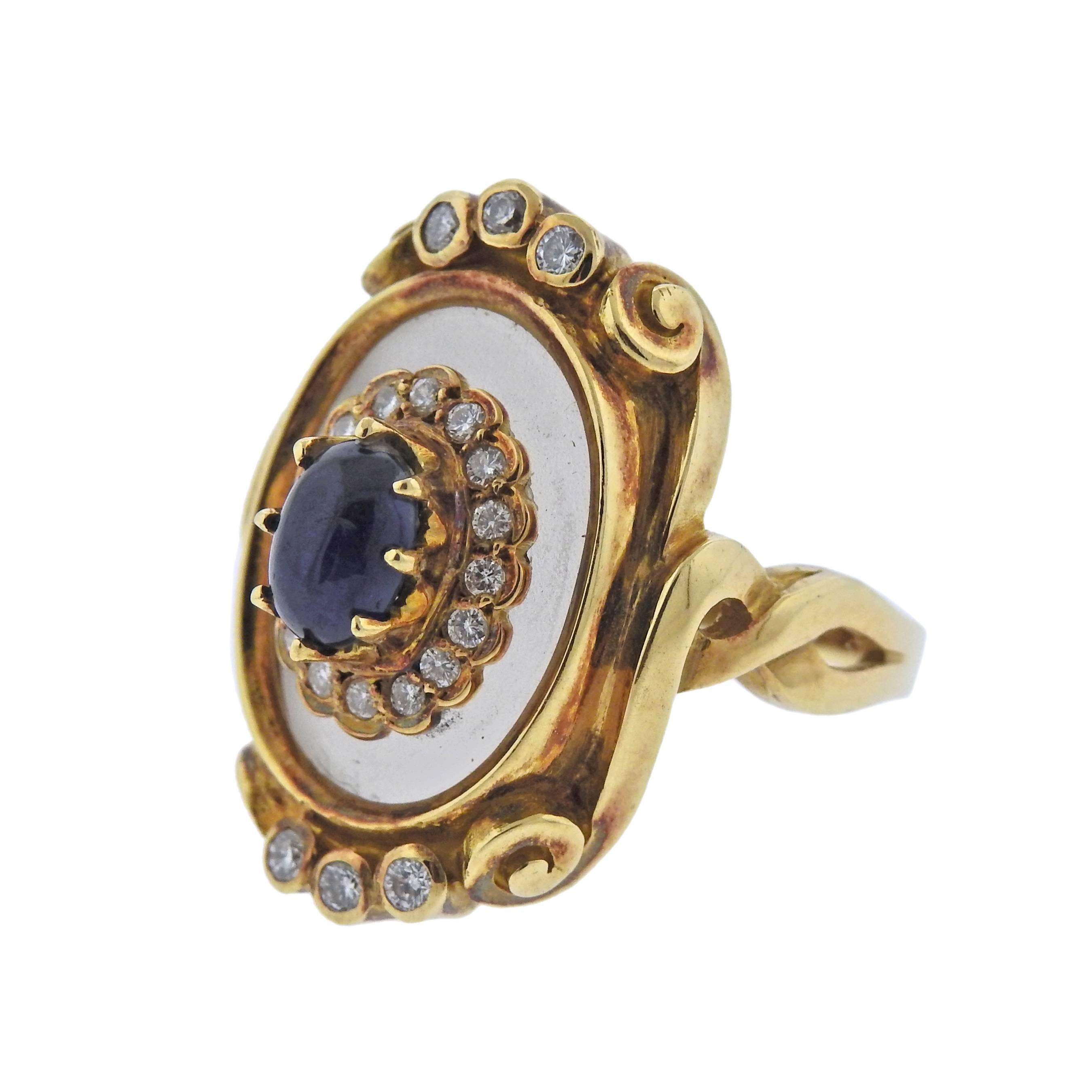18k yellow gold ring by Greek designer Ilias Lalaounis, featuring frosted crystal top, approx. 0.24ctw in diamonds and 5mm x 7mm sapphire cabochon. Ring size - 7, ring top - 25mm x 18mm, weighs 12.3 grams. Marked: 750, A21, Maker's mark, Greece.