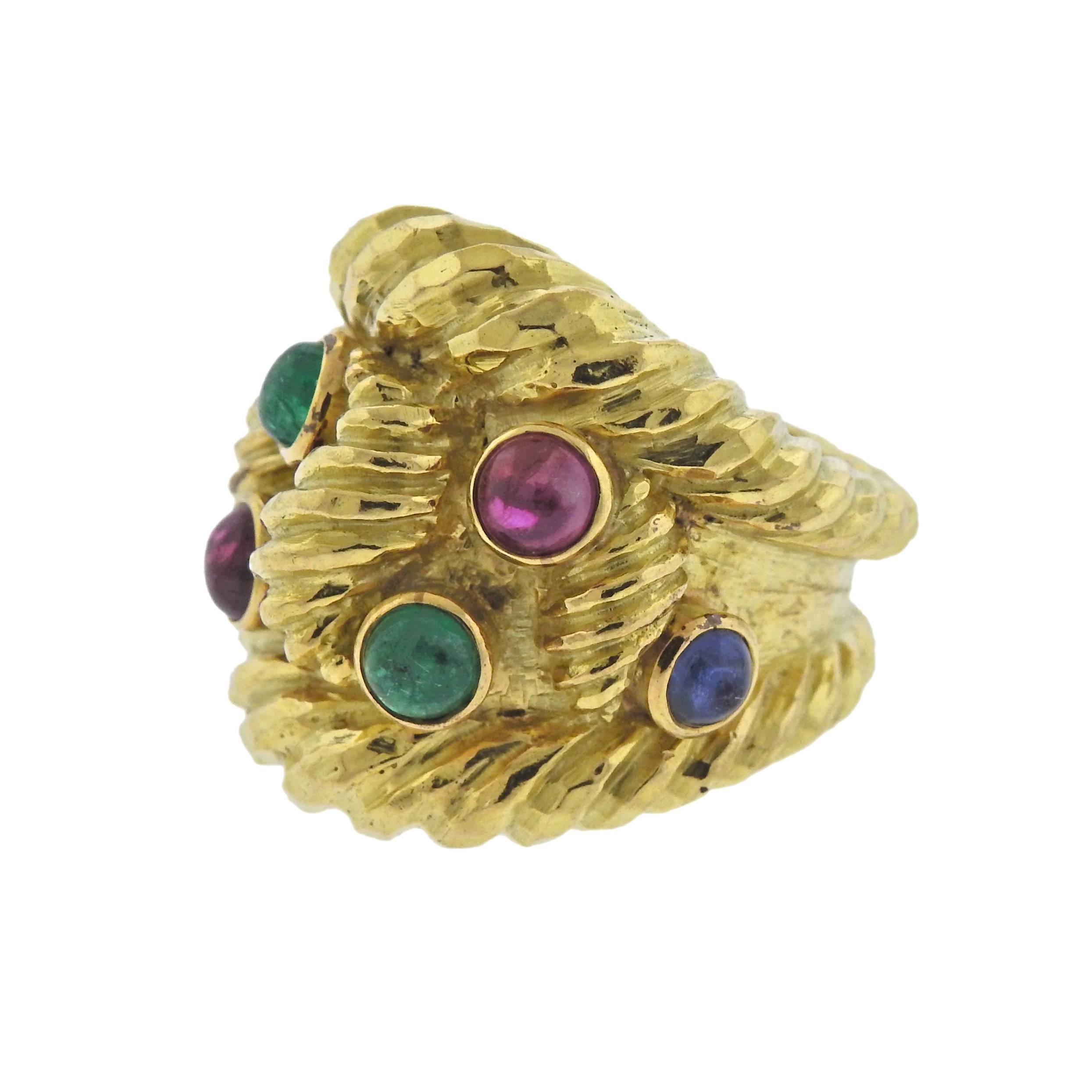Impressive large 18k hammered gold ring by David Webb, decorated with ruby, sapphire and emerald cabochons. Ring size - 6 3/4, ring top is 25mm at widest point , weighs 31.8 grams. Marked: 18k, Webb.