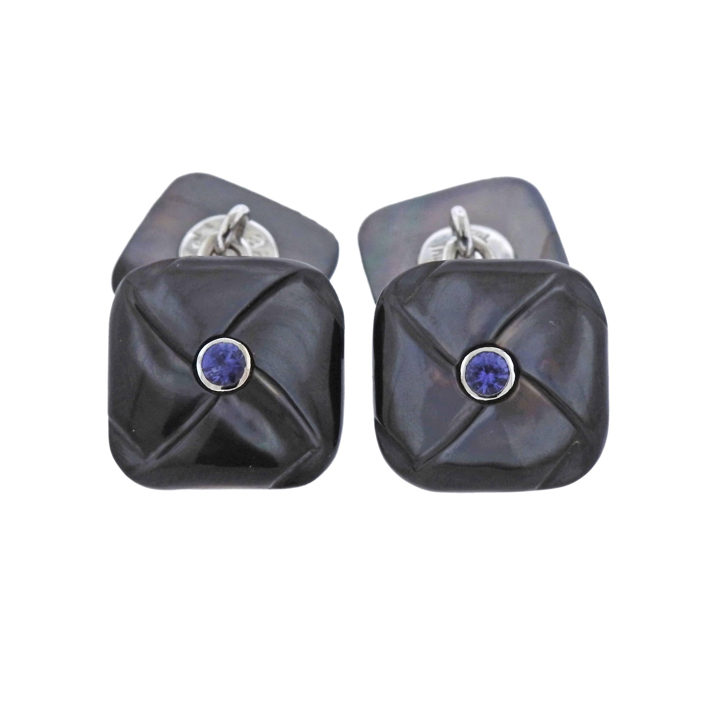 Pair of 18k white gold cufflinks by Trianon, featuring mother of pearl top, with iolite in the center. Larger top - 14mm x 14mm, smaller - 12mm x 12mm. Weight of the set - 6.5 grams. Marked: Maker's mark, Trianon, 750.
