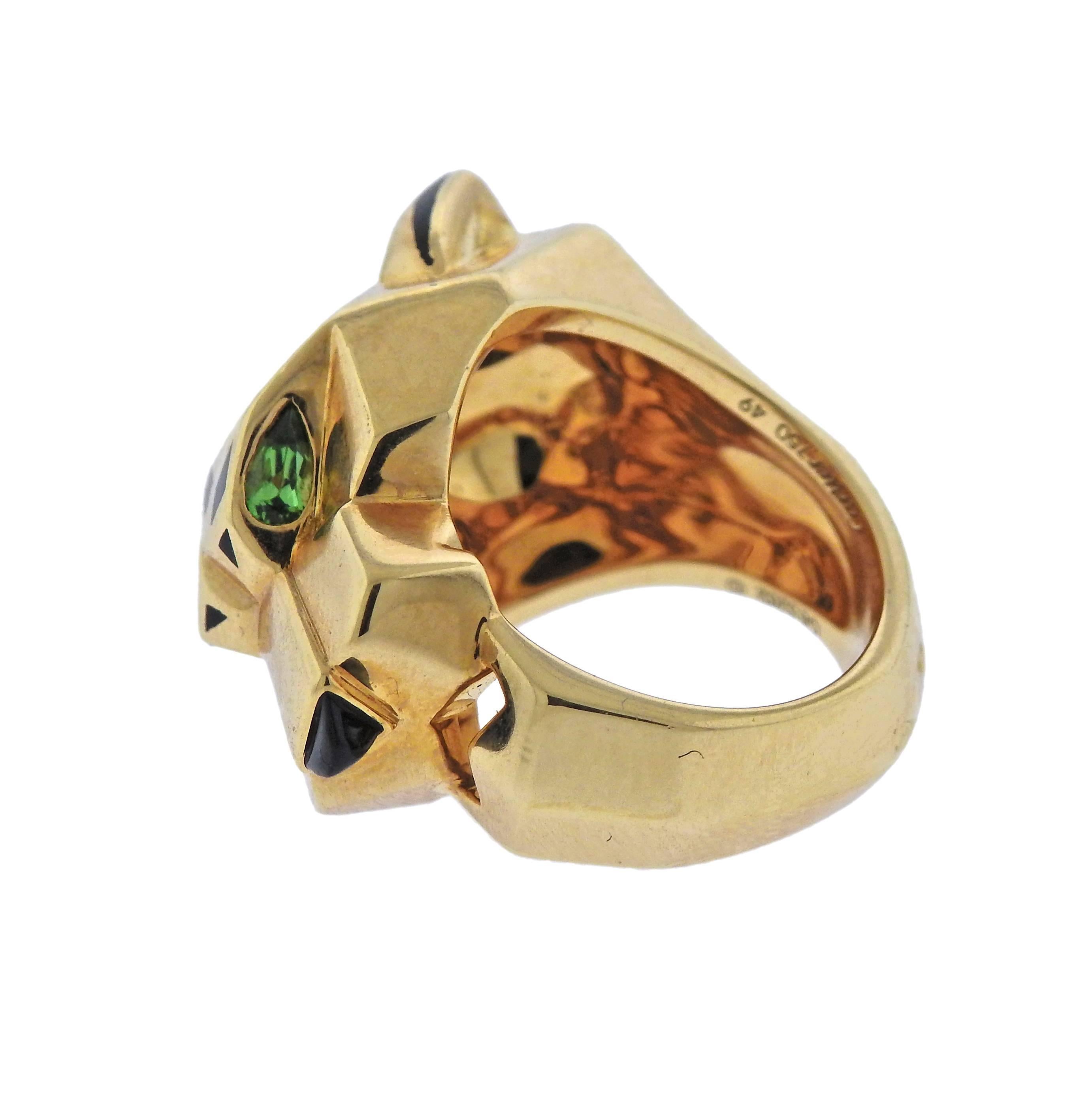 Iconic Panthere ring by Cartier, decorated with emerald eyes, onyx nose and enamel. Ring size - 5, ring top - 18mm x 25mm, weighs 23.7 grams. Marked: French assay marks, Cartier, 750, 49, OE5262.
Retail $11200.