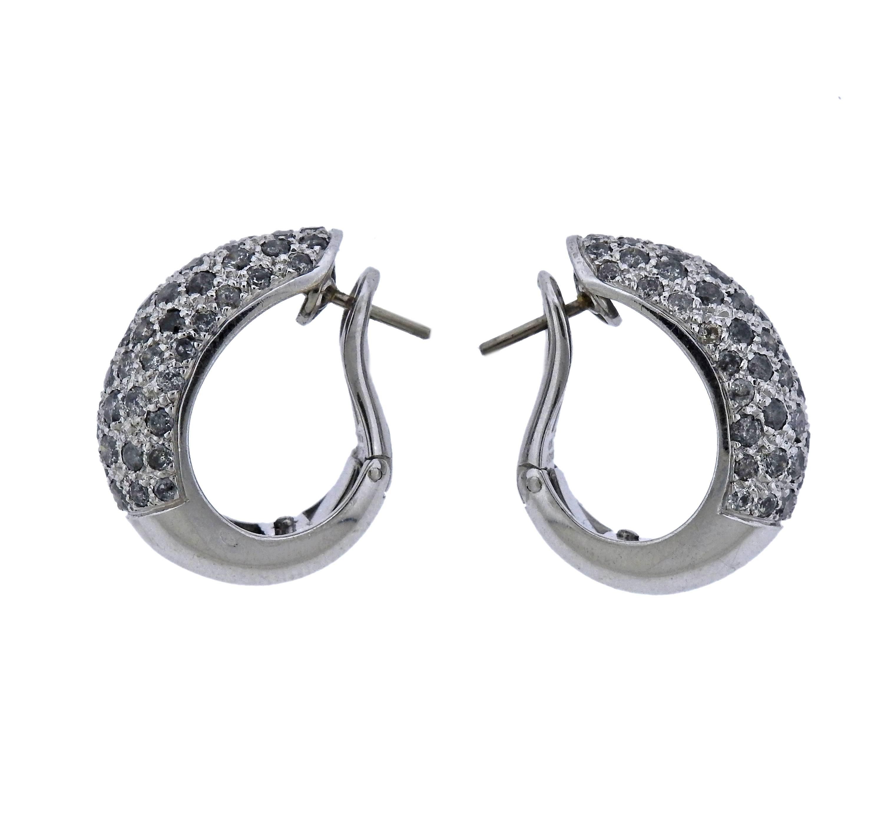Pair of Cartier Sauvage 18k gold hoop earrings, crafted in circa 1990s, set with approx. 2.50ctw in diamonds. Earrings are 22mm x 10mm, weigh 15.7 grams. Marked: Cartier, 1999, 750, H86032. 