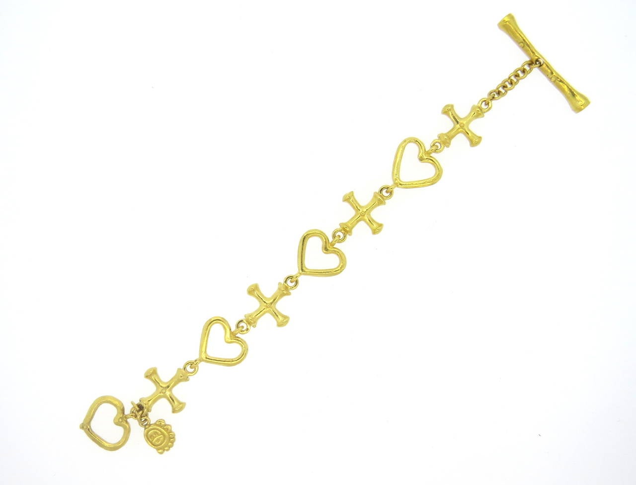 22k yellow gold bracelet by Denise Roberge, featuring alternating heart and cross links with toggle closure. Bracelet is 8