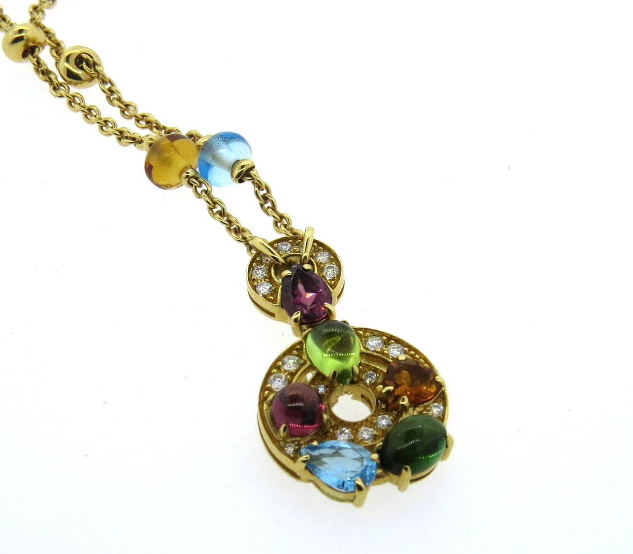 Bulgari 18k gold necklace with pendant from Concentrica collection, crafted with approx. 0.25ctw in G/VS diamonds , blue topaz, tourmaline, citrine and peridot. Necklace length is adjustable from 15