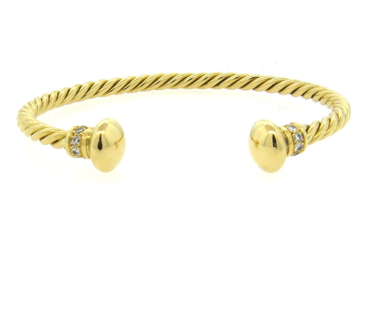 18k gold cuff bracelet, crafted by Bulgari, decorated with approx. 0.24ctw in G/VS diamonds. Bracelet will fit up to 7