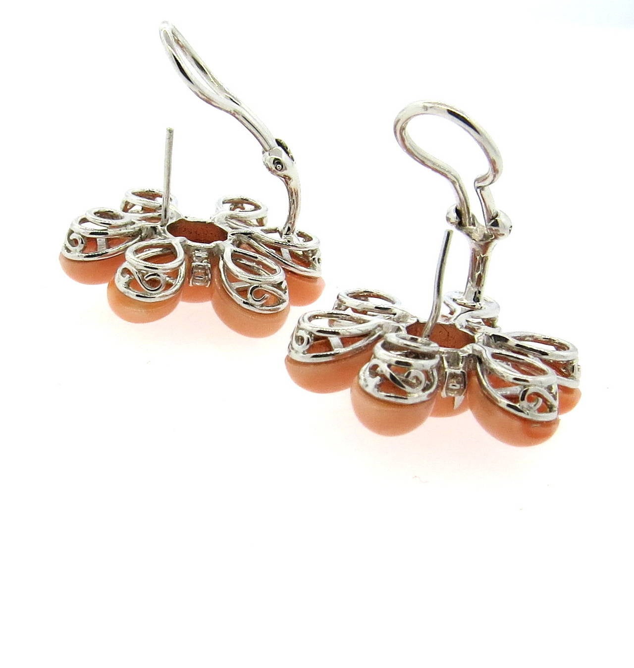18k gold earrings, set with coral stones and approximately 0.48ctw in diamonds, featuring flower motif design. Earrings are 28mm x 28mm. Weight - 18.5 grams