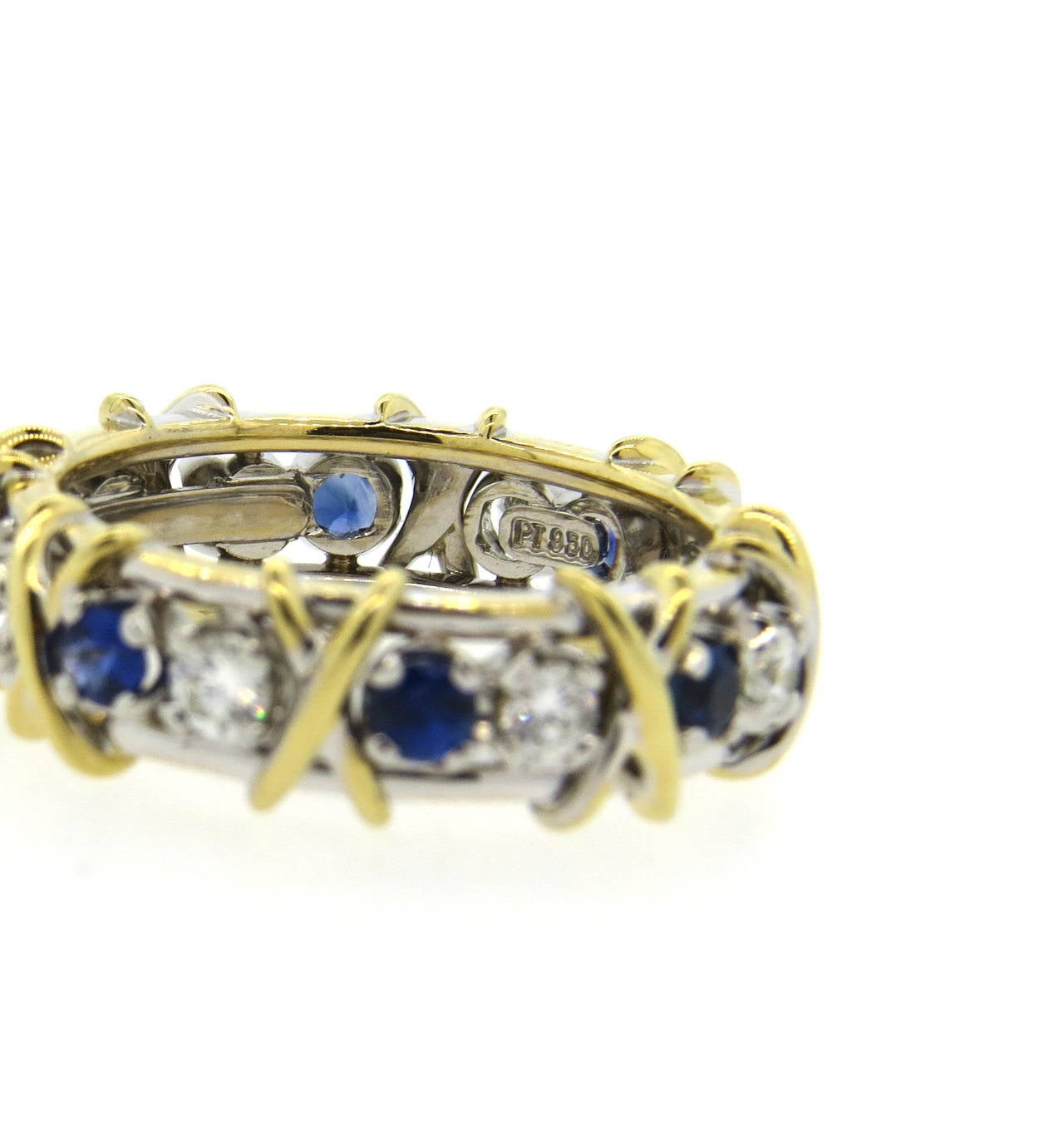 Tiffany & Co band ring, designed by Jean Schlumberger for iconic Sixteen stone collection, set in 18k gold and platinum , featuring approximately 0.59ctw in diamonds and 0.75ctw in blue sapphires. Ring is a size 7 1/2, ring is 7mm wide. Marked