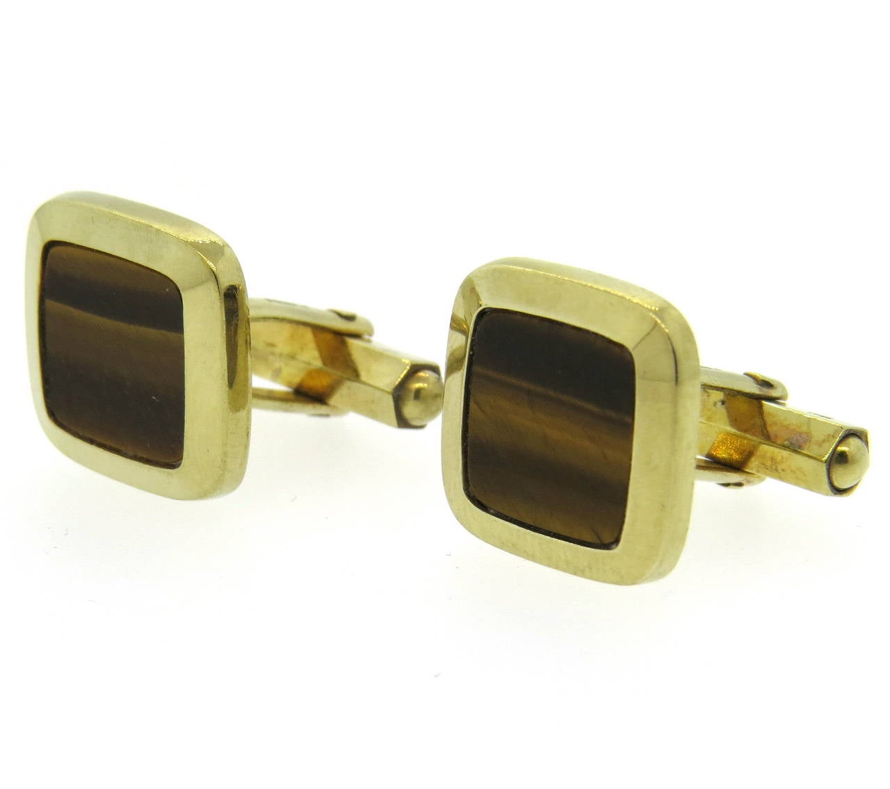 A pair of 9k yellow gold cufflinks, set with tiger's eye.  Crafted in England, the cufflinks measure 16mm x 16mm and weigh 9.2 grams.  Marked with English hallmarks and 375.