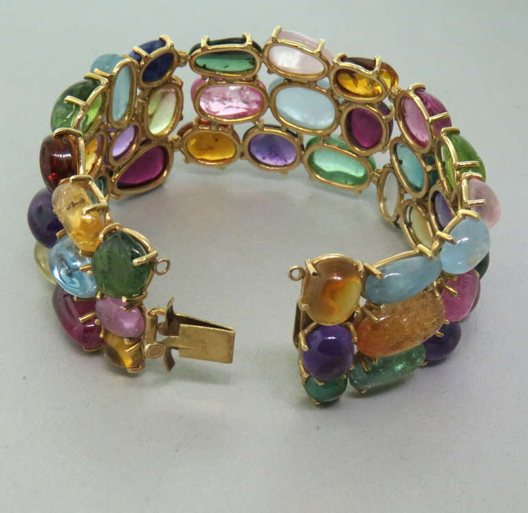 1960s vintage 14k yellow gold bracelet with multi color cabochon gemstones,featuring green tourmaline,amethyst,citrine,aquamarine,blue topaz,peridot,moonstone,lapis,quartz. Bracelet is 7