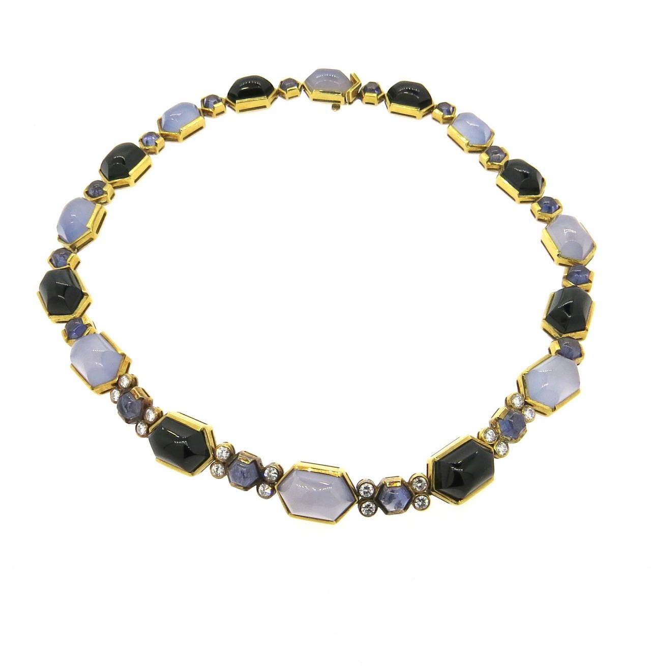 An 18k yellow gold necklace set with approximately 2.00ctw in G/VS diamonds, chalcedony, iolite and onyx.  Crafted in Italy, the necklace is 17" long and 12mm wide.  The piece weighs 85.6 grams.  Marked 750, 18k, Italian Assay Marks, Italy.