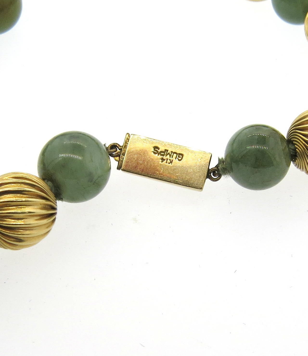 14k gold necklace by Gumps, featuring 10mm to 11.4mm jade beads. Necklace is 27 1/4