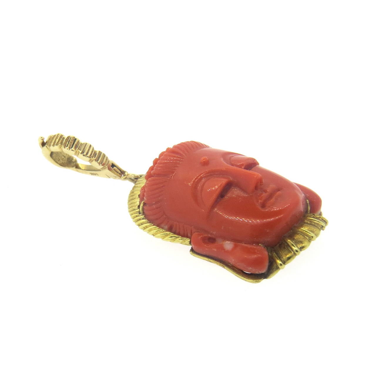 14k gold pendant, featuring carve coral stone. Pendant is 55mm long including the bale x 25mm wide. Marked 14k and Trio. Weight of the piece - 19.1 grams