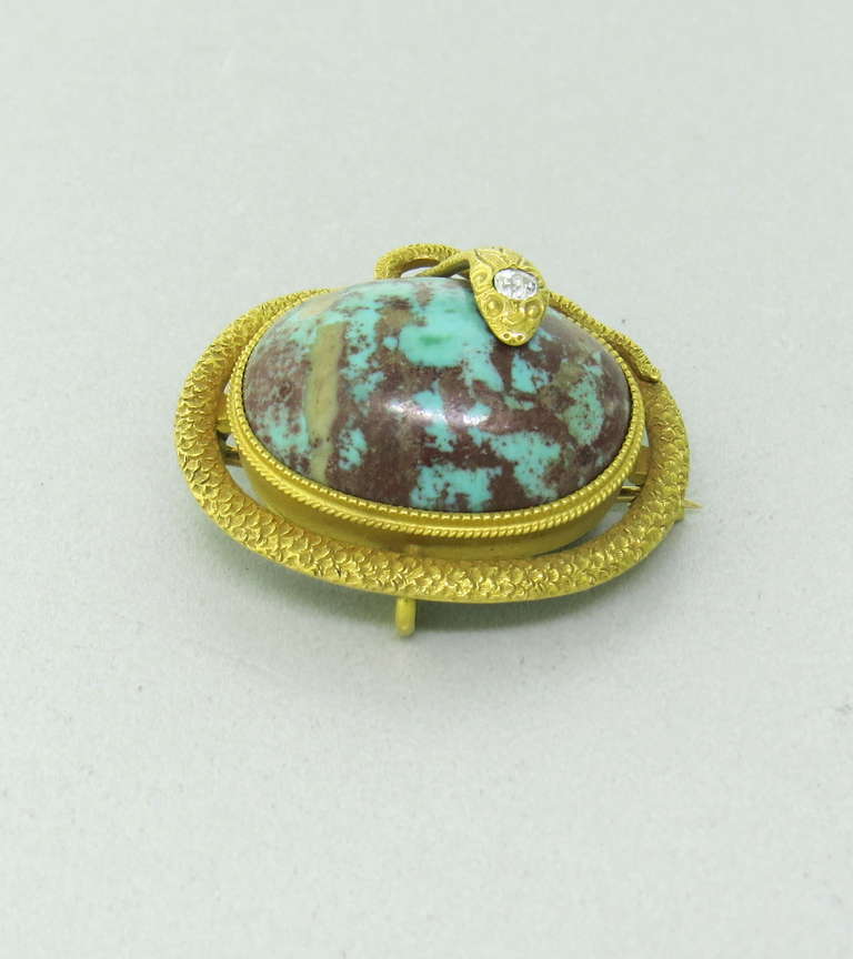 14k gold brooch/pendant by Krementz with snake,wrapped around turquoise gemstone. Brooch is 30mm x 26mm. Marked by maker and 14k. weight - 11.2g
