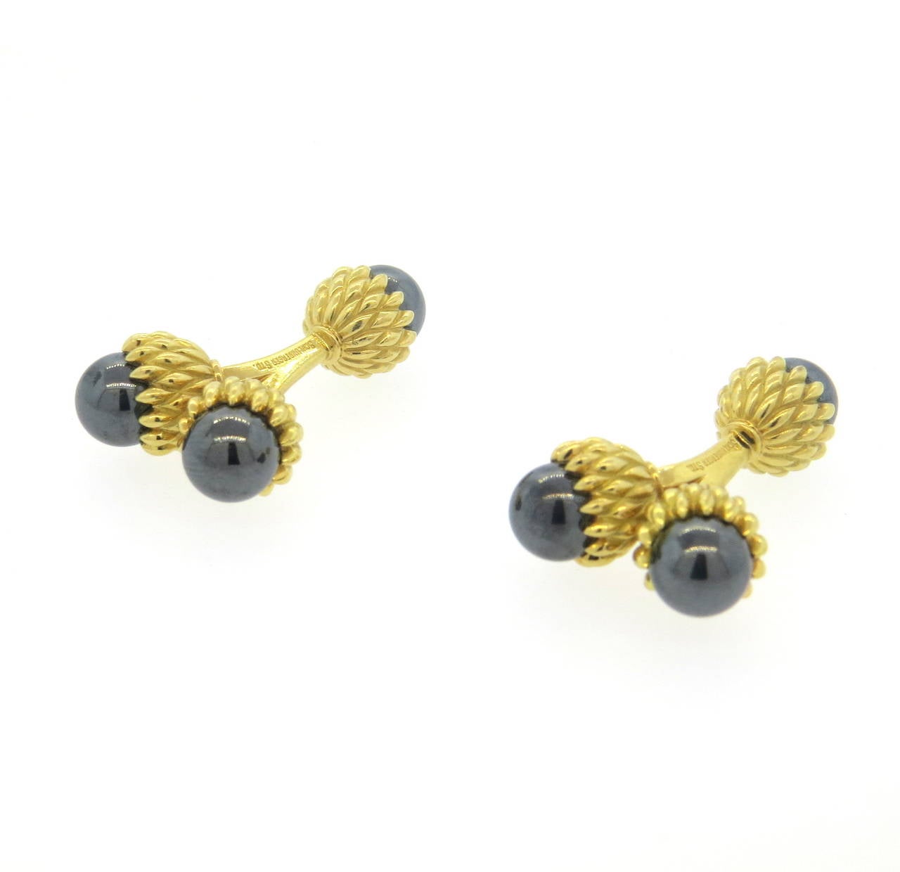 A pair of 18k yellow gold acorn motif cufflinks, set with hematite (7.5mm).  Crafted by Jean Schlumberger for Tiffany & Co., the cufflinks measure 20mm x 10mm in the front and 10mm in diameter in back.  The weight of the cufflinks is 26.1 grams.