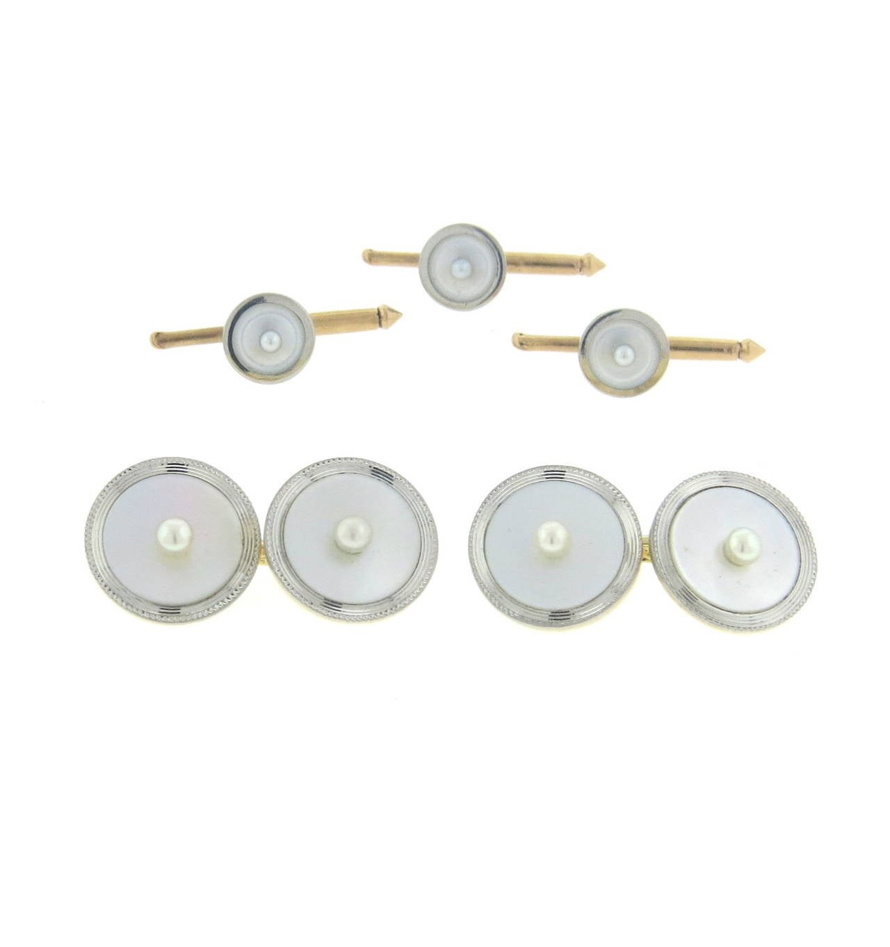 A 14k yellow gold and platinum cufflinks and studs set set with mother of pearl and seed pearls.  Crafted by Cartier, the cufflinks measure 14mm in diameter and the studs measure 8mm in diameter.  The weight of the set is 12.9 grams.  Marked: