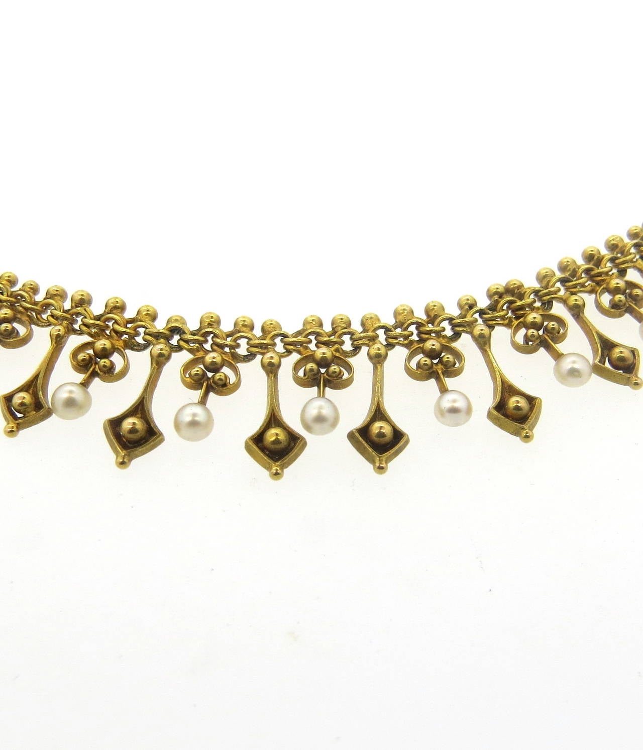 A 14k yellow gold necklace set with natural pearls 2.5mm in diameter.  The necklace is 15.5
