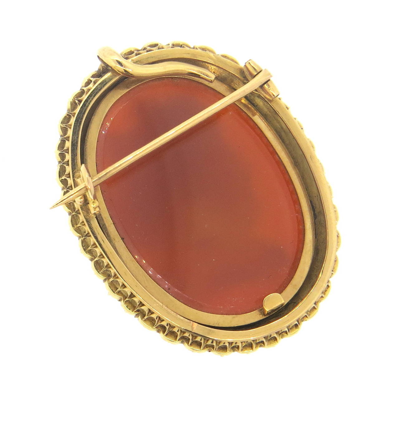 An 18k rose gold hard stone cameo surrounded by natural pearls 3.2mm in diameter.  This antique piece measures 50mm x 37mm and weighs 30.6 grams.  This can be worn as a brooch or the hardware in back can be removed for use as a pendant.