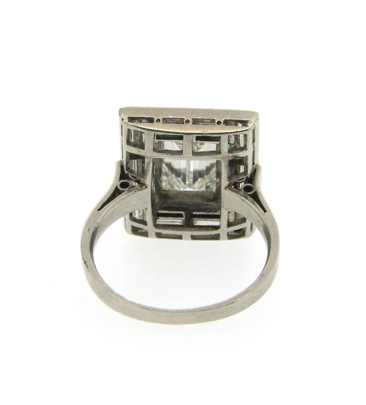 1920s Art Deco platinum engagement ring, featuring an emerald cut center diamond, approximately 2ct VS1-H, surrounded with ten baguette cut diamonds and emeralds. Ring is a size 6 3/4, ring top is 17mm x 15mm. Weight - 8.8 grams