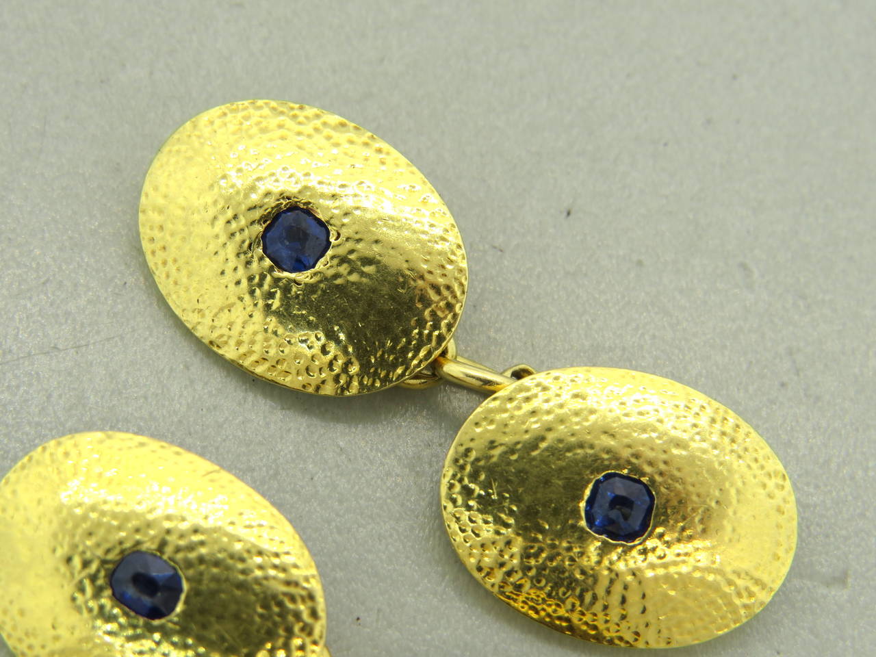 18k yellow gold Mappin & Webb cufflinks set with sapphires , hammered finish, 19mm X 14mm . Weight 18.6g