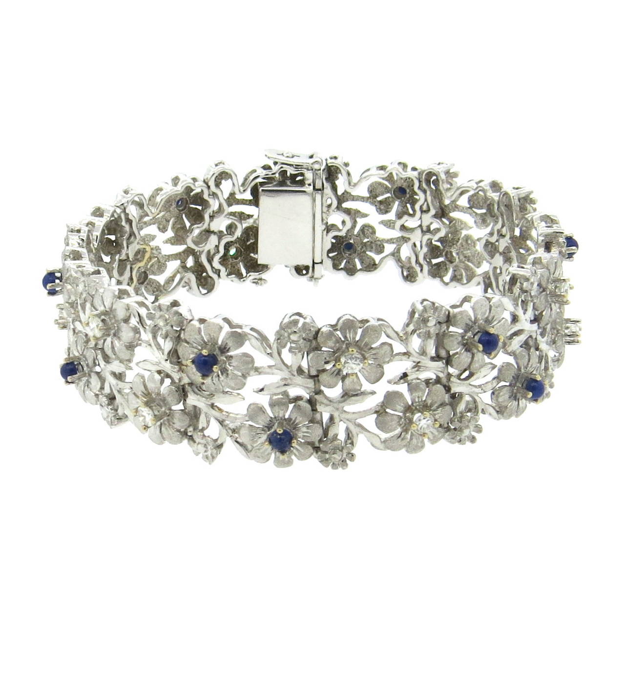 European circa 1960s bracelet, crafted in 18k white gold, featuring flower design, set with lapis lazuli and approximately 0.75ctw in diamonds. Bracelet is 7 1/8