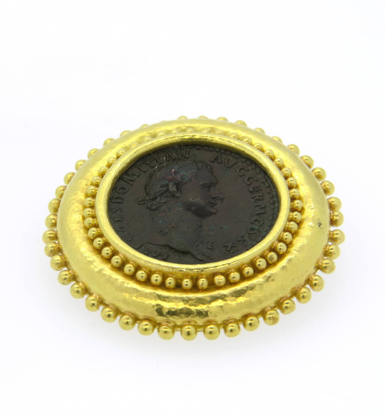 An 18k yellow gold brooch set with an ancient coin.  Crafted by Elizabeth Locke, the brooch measures 46mm in diameter and weighs 37.1 grams.